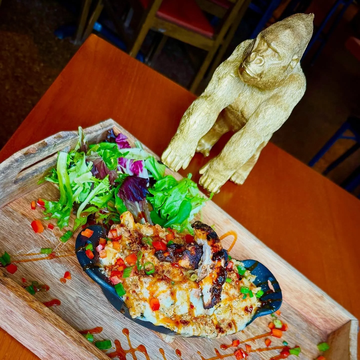 Jerk Chicken Mac &amp; Cheese- Campanelle pasta tossed in our house-made creamy cheese blend with house made jerk chicken thighs, topped with Monterey jack cheese, panko breadcrumbs, red pepper, green onion and sweet chili reduction