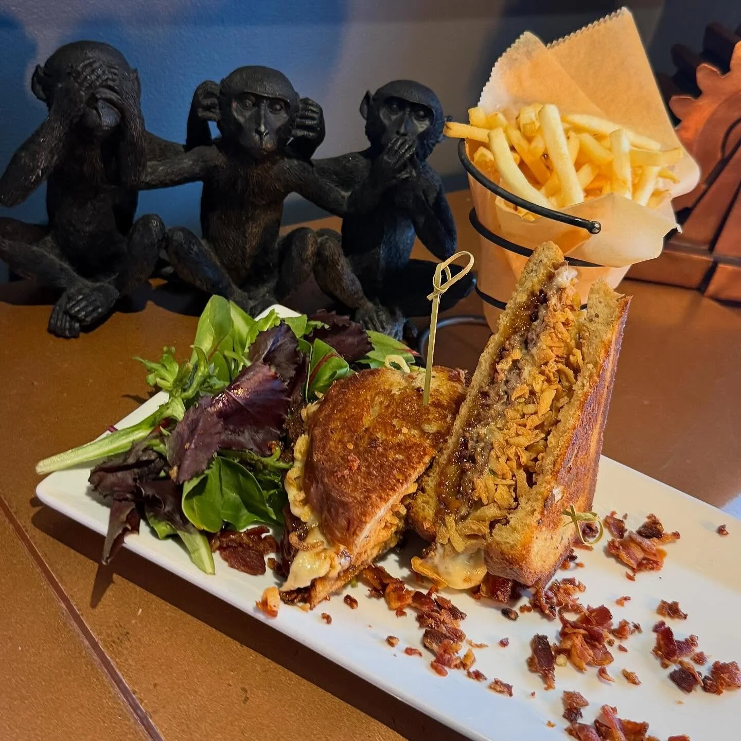 Peach Bourbon Smash Burger- Double hand pressed angus beef smash patties on thick cut rye bread with smoked gruyere cheese, bourbon bacon peach jam and fried onions. Served with French cut fries