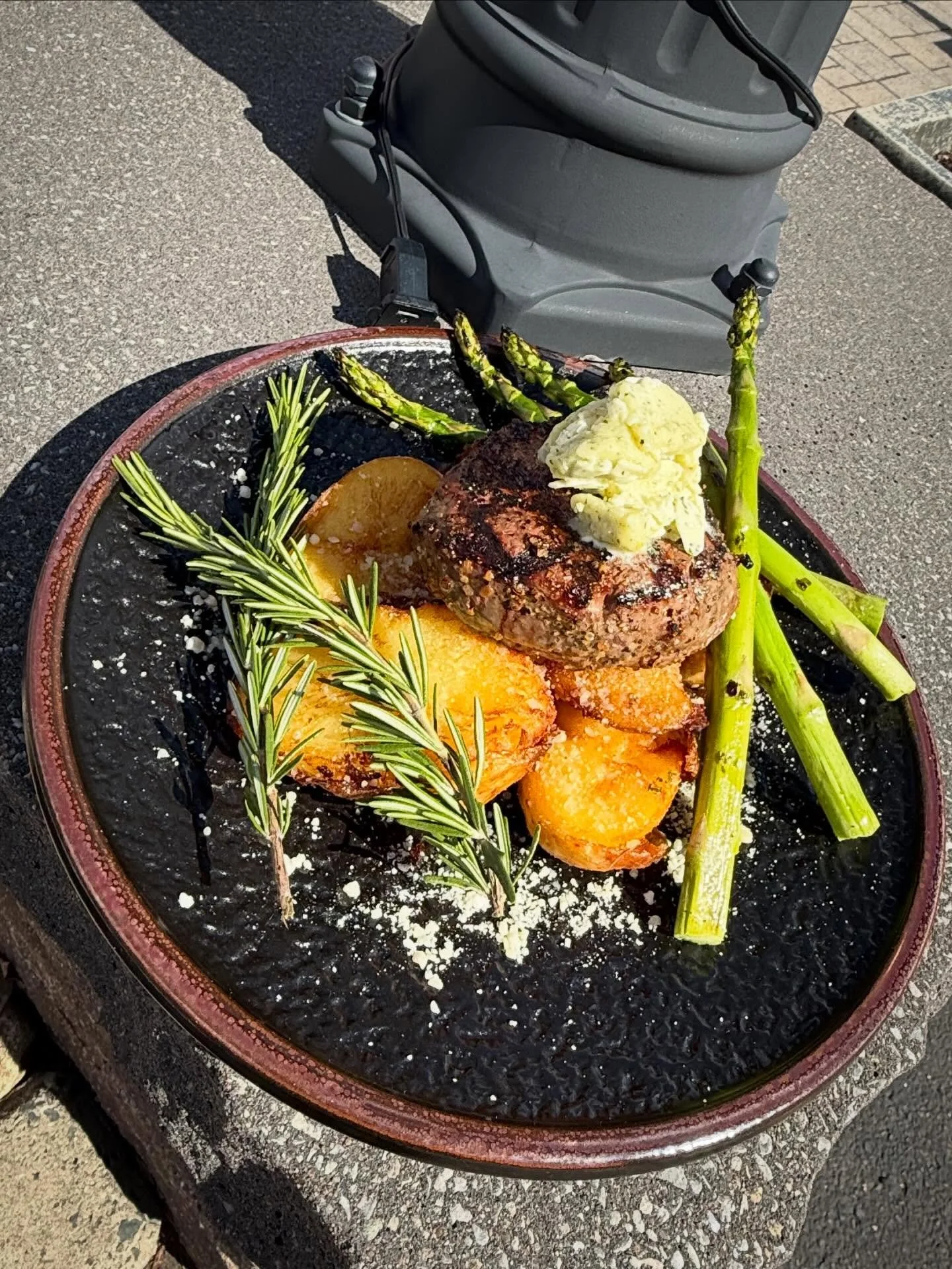 First Class Filet- 8 oz center cut filet grilled with our house steak rub, served over truffle parmesan smashed potatoes, finished with grilled asparagus and a truffle garlic butter