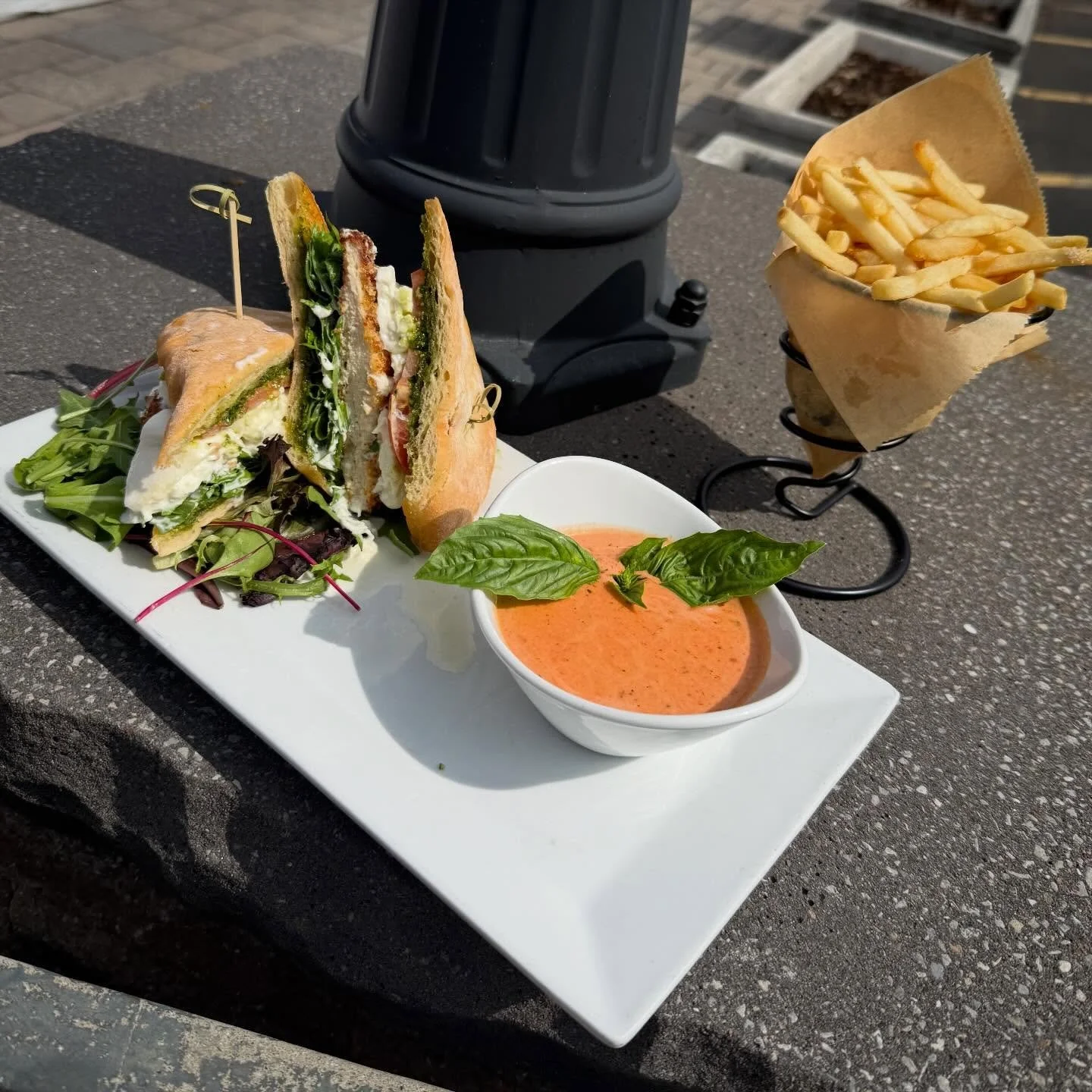 Vodka Velocity Chicken Sandwich- Crispy panko chicken topped with fresh burrata, peppery arugula, and ripe tomato, finished with a pistachio pesto on toasted ciabatta. Served with a side of vodka cream sauce and French cut fries