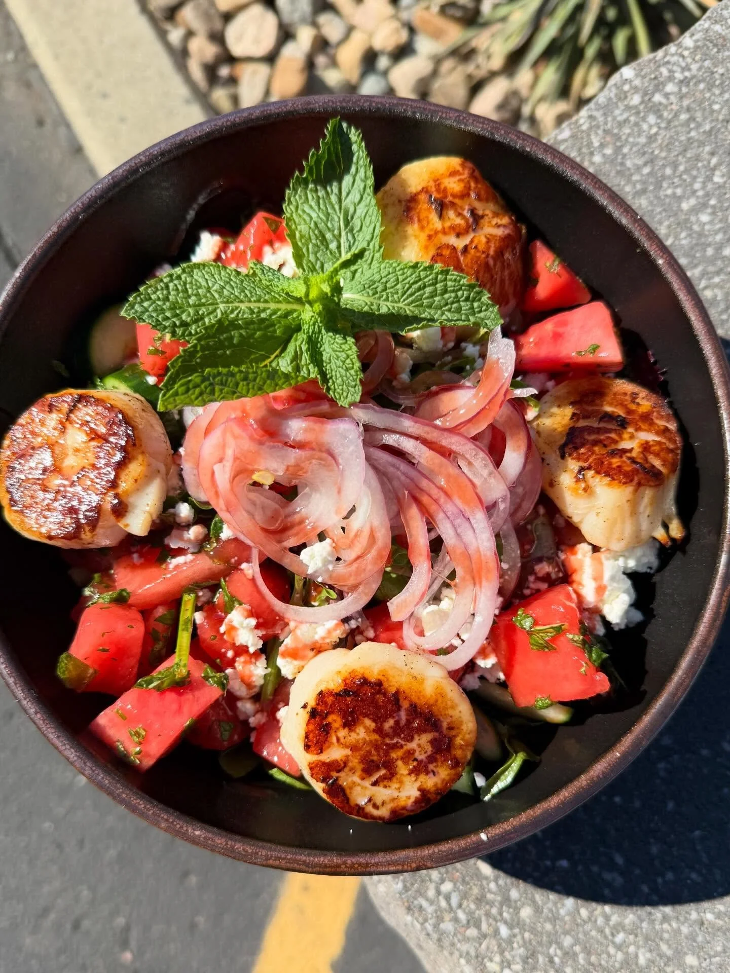 Watermelon Mint Salad- Mixed greens tossed with balsamic vinaigrette, topped with diced watermelon, fresh mint, cucumbers, goat cheese and shaved red onion. Finished with jumbo seared sea scallops and a guava puree