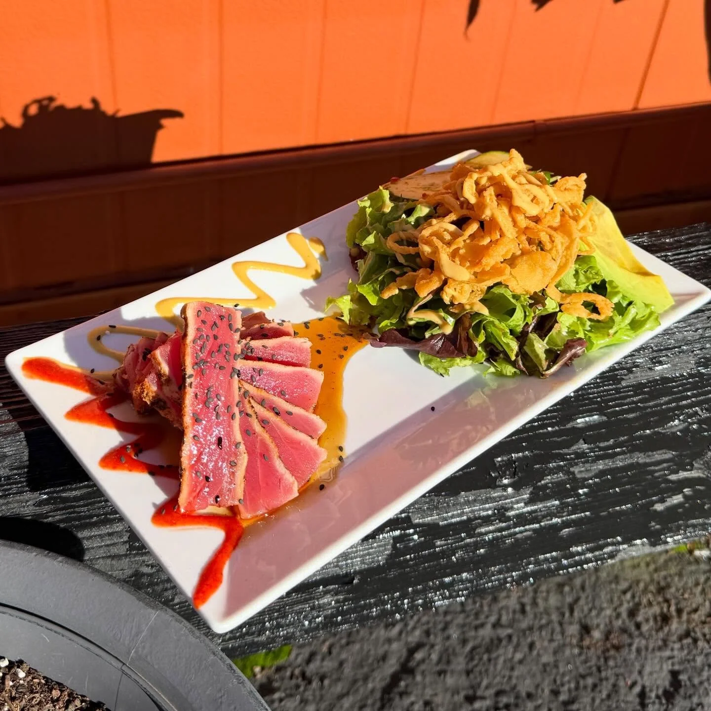 Ahi Tuna- AAA Yellowfin tuna seared rare with blackened seasoning. Served with a side of mixed greens tossed in a spicy honey mustard dressing. Garnished with fried onion straws, sweet chili cucumbers and sliced avocado