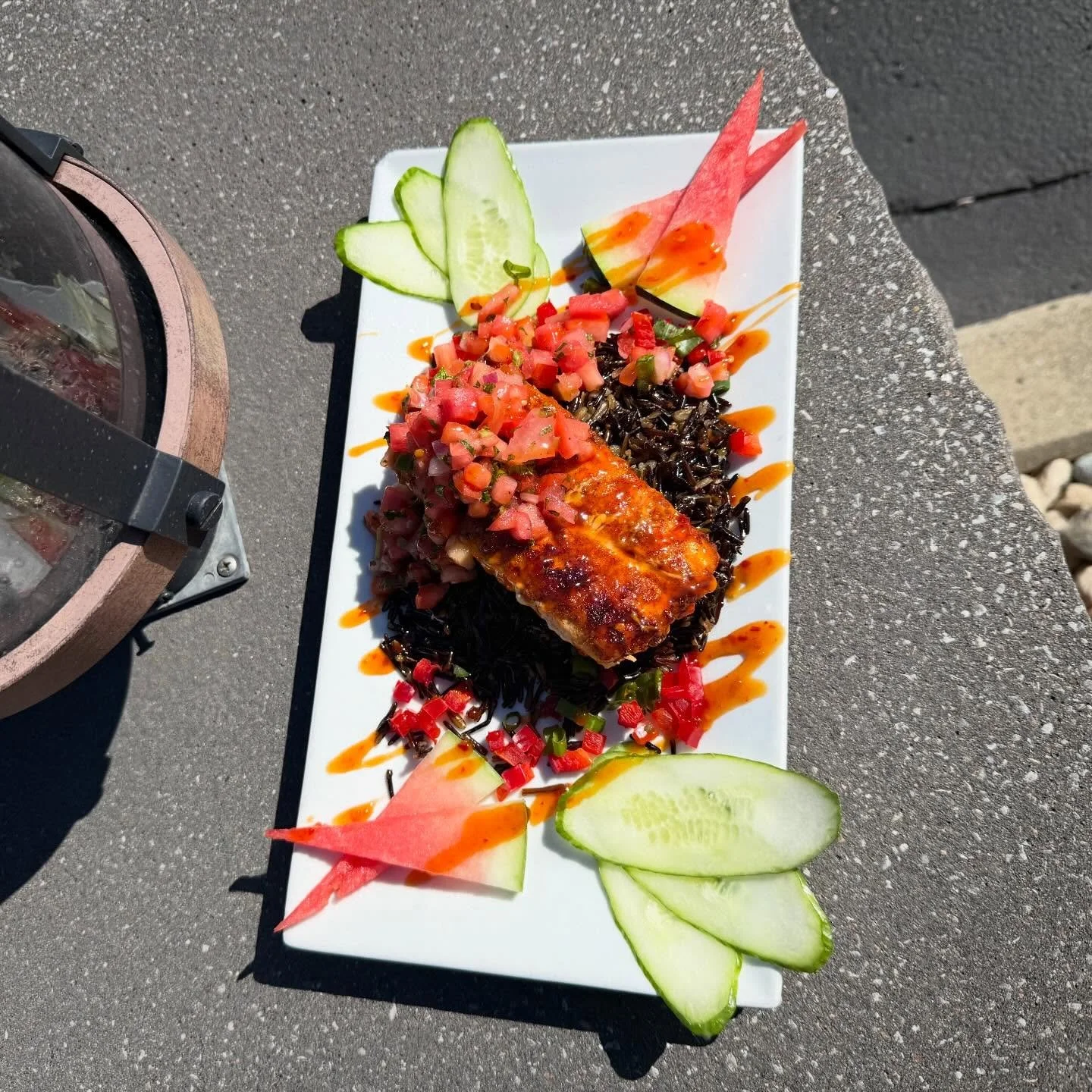 Watermelon Mahi- 8 oz center cut mahi Mahi blackened and served over black rice, topped with a watermelon salsa and finished with shaved cucumbers