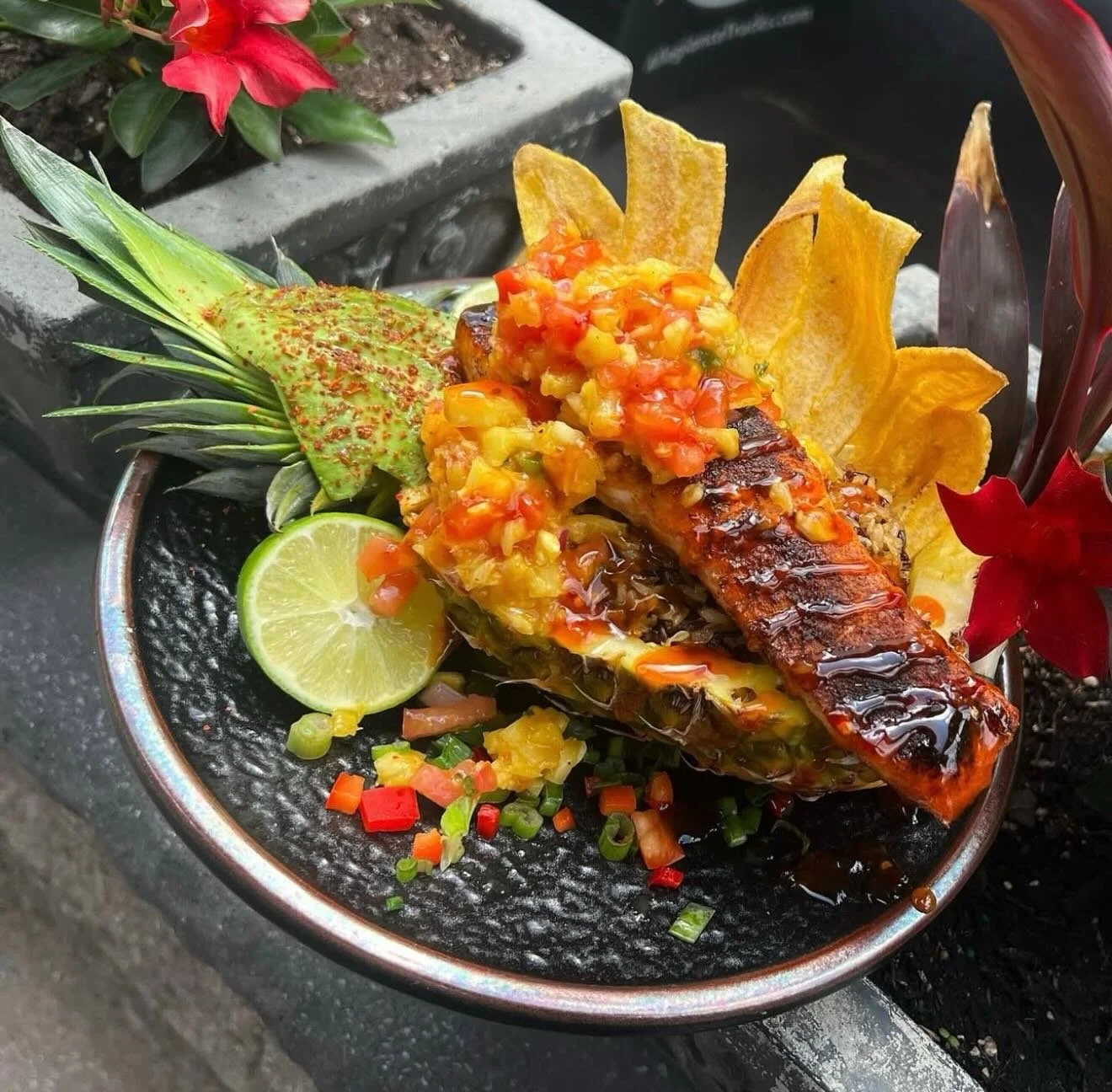 Pineapple Tequila Bowl -Pineapple stuffed with wild rice, pineapple mango salsa and avocado. Finished with a sweet chili sauce and Tajin. Finished with 8 oz blackened Atlantic Salmon