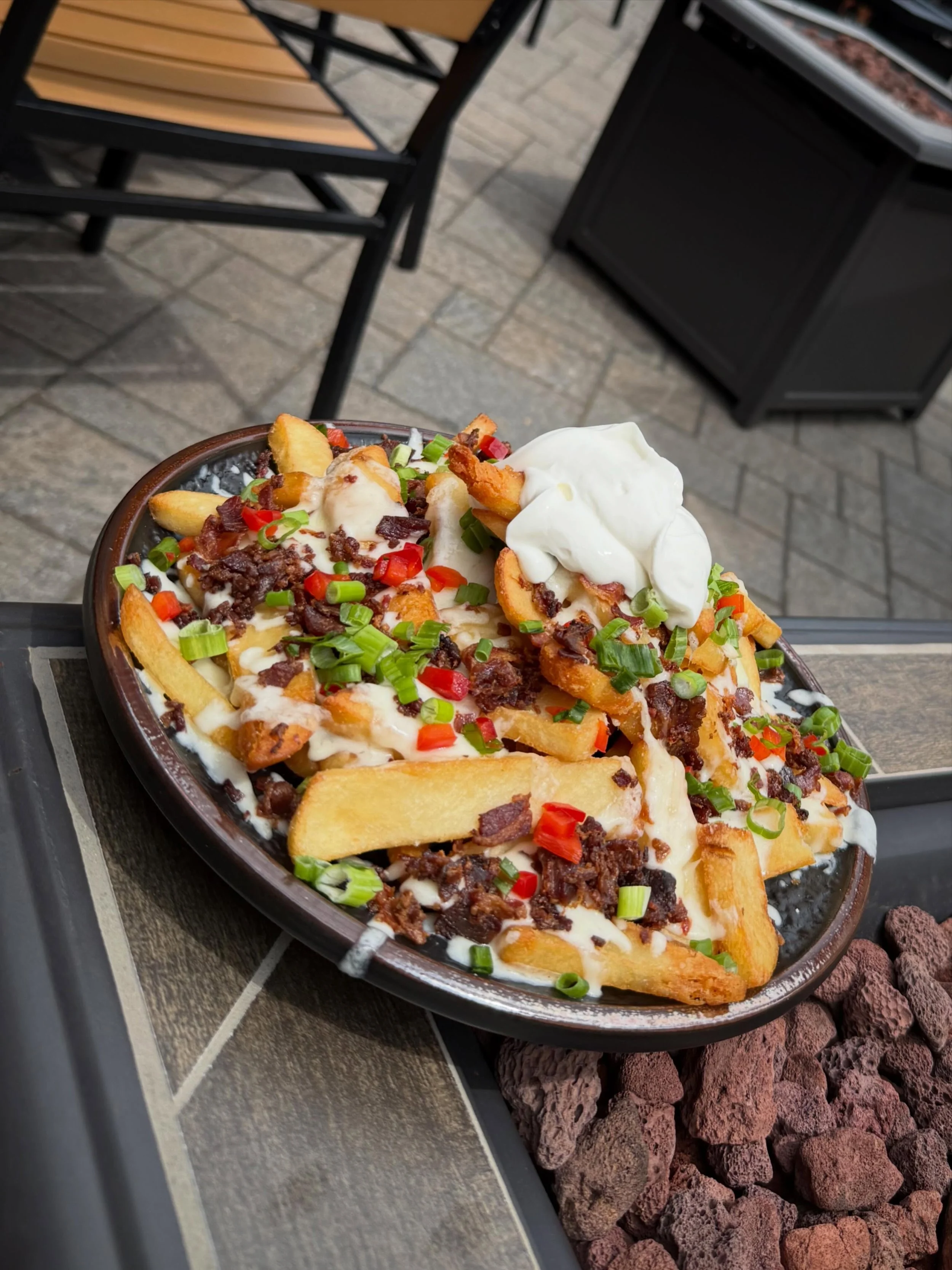 Loaded Steak Fries- Crispy thick cut steak fries, topped with Monterey Jack cheese, bacon, green onion, red pepper and finished with sour cream.