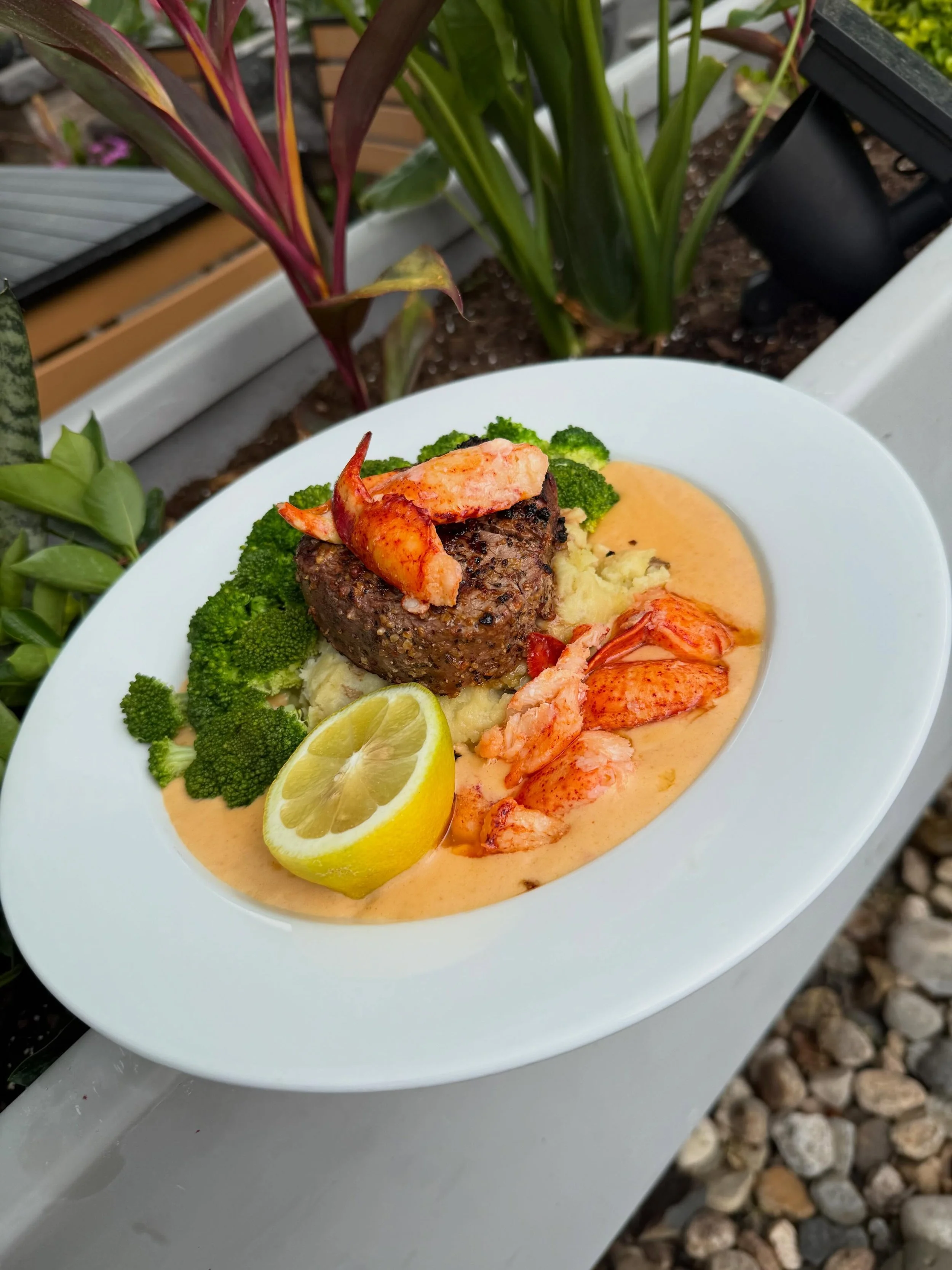 Surt &amp; Turf- 8 oz center cut filet mignon seasoned with our house steak rub, topped with butter poached lobster.
Served over a lobster &amp; sherry cream sauce, golden Yukon potato puree and steamed broccoli
