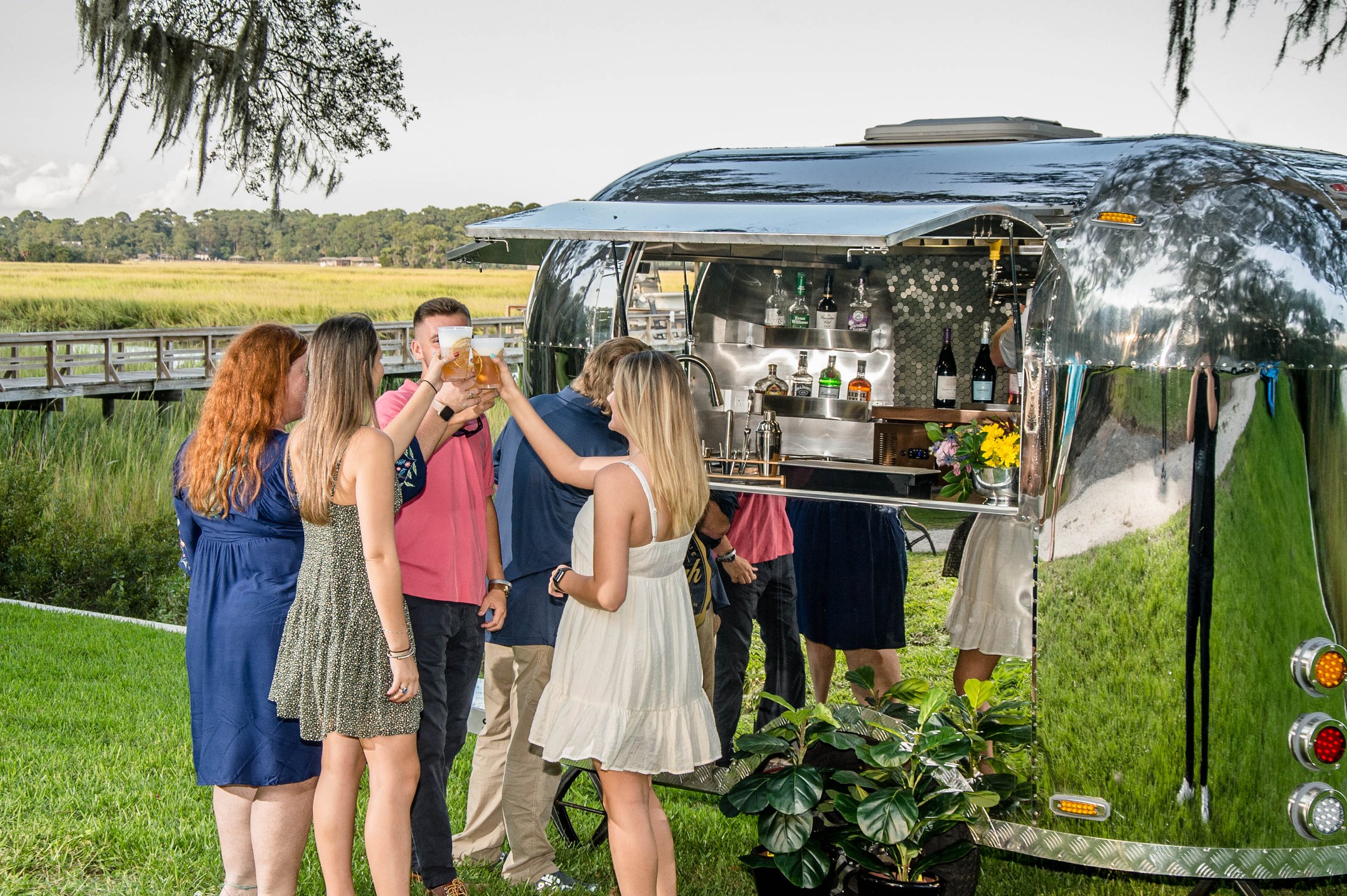 Guests Toasting in front of the Portable Vintage Beverage Cart Trailer for Rent in Alabama.jpg