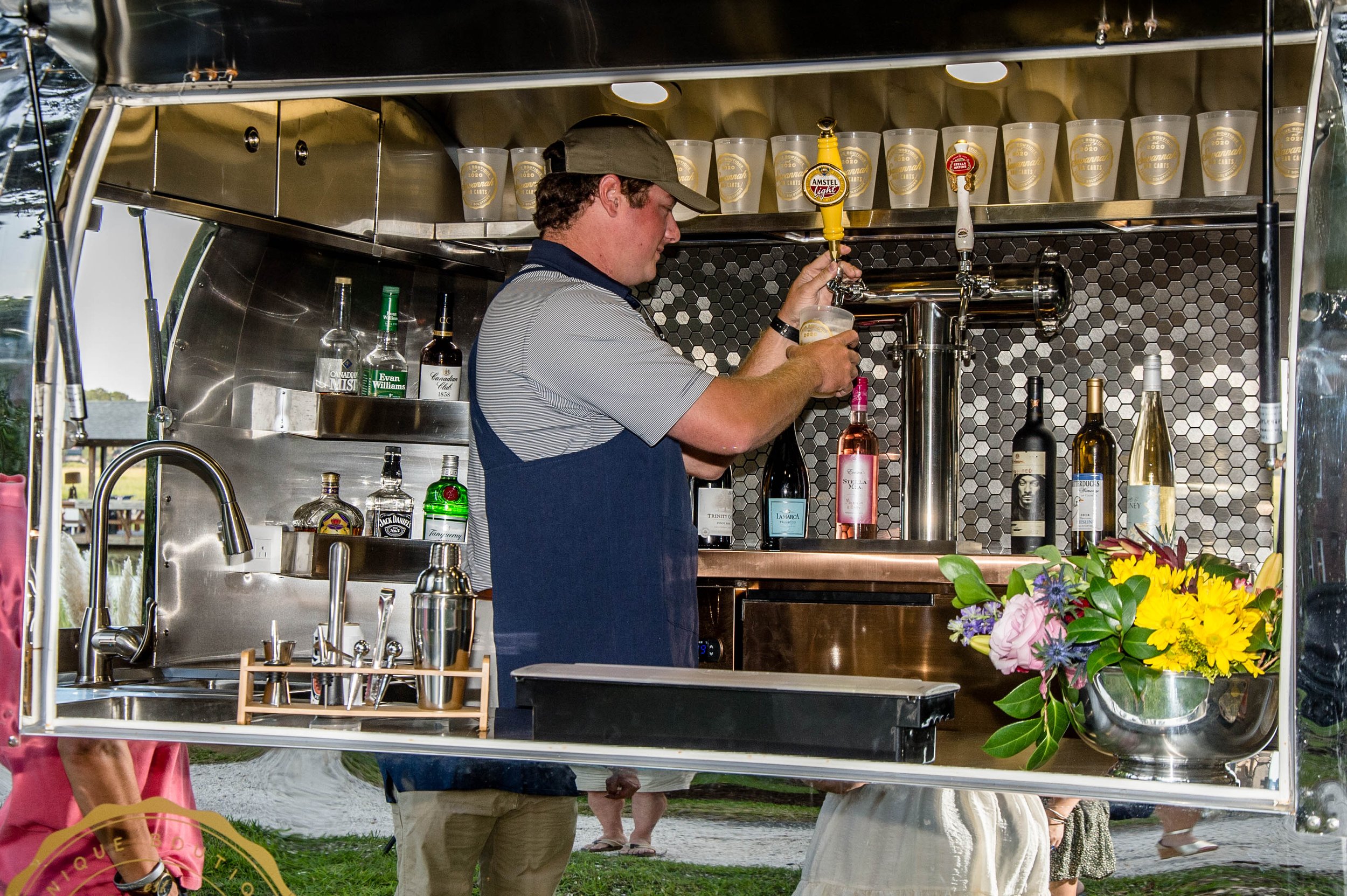 Bartender Serving Up Drinks in the Rentable Vintage Beverage Cart Trailer in Alabama.jpg