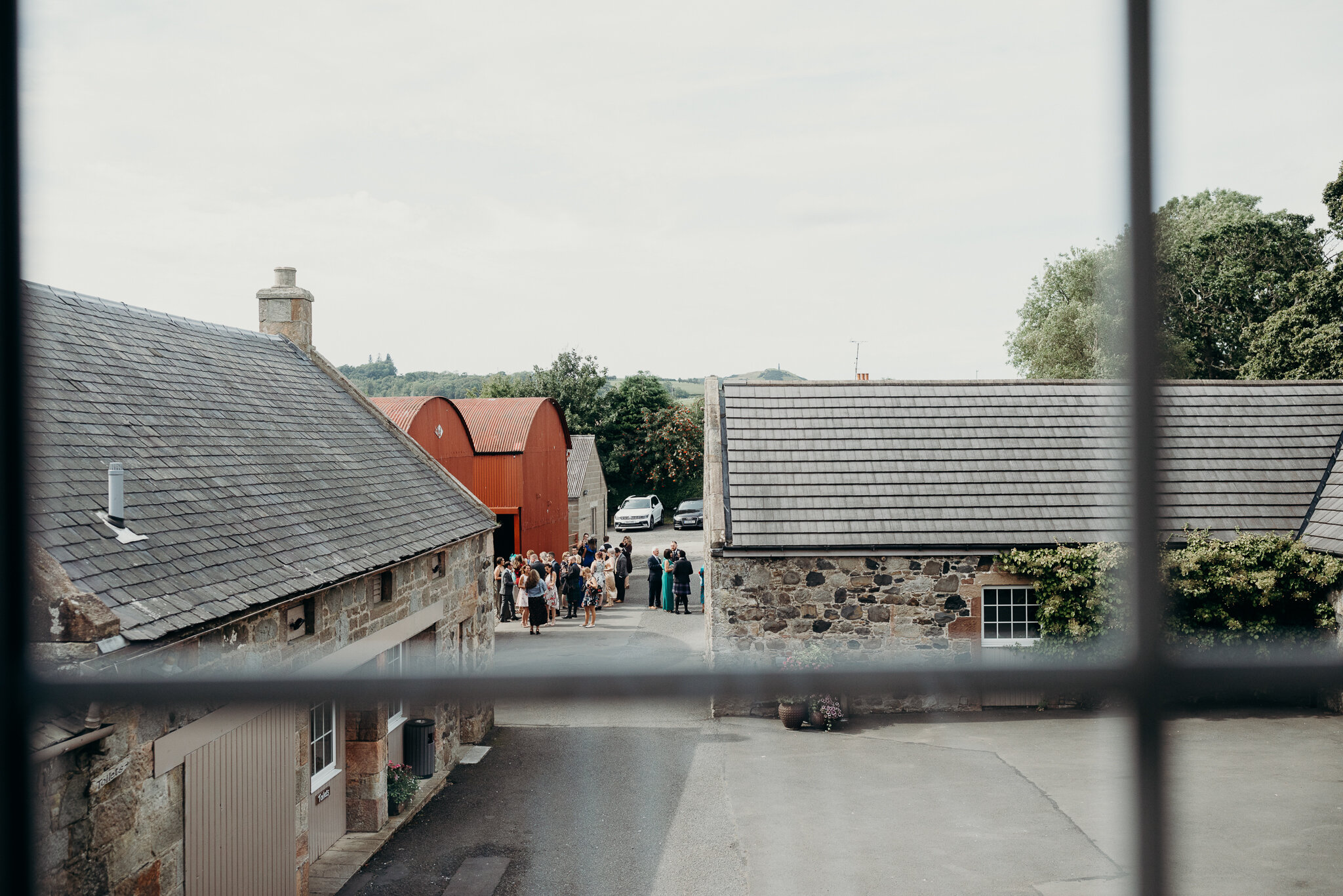 exterior view from window at dalduff farm of wedding guests photographed by wedding photographer ayrshire