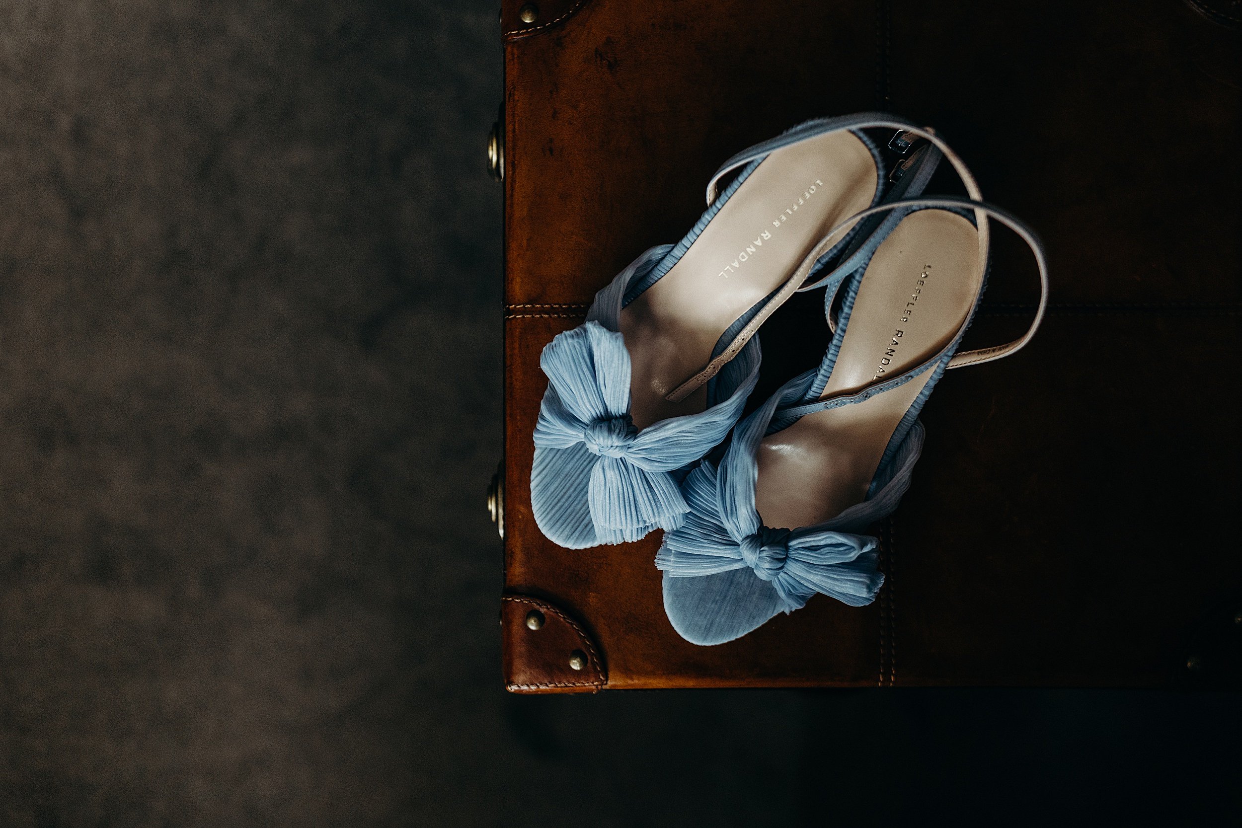 baby blue Loeffler Randall bridal shoes on top of brown suitcase during bride's preparations for the bothy glasgow wedding