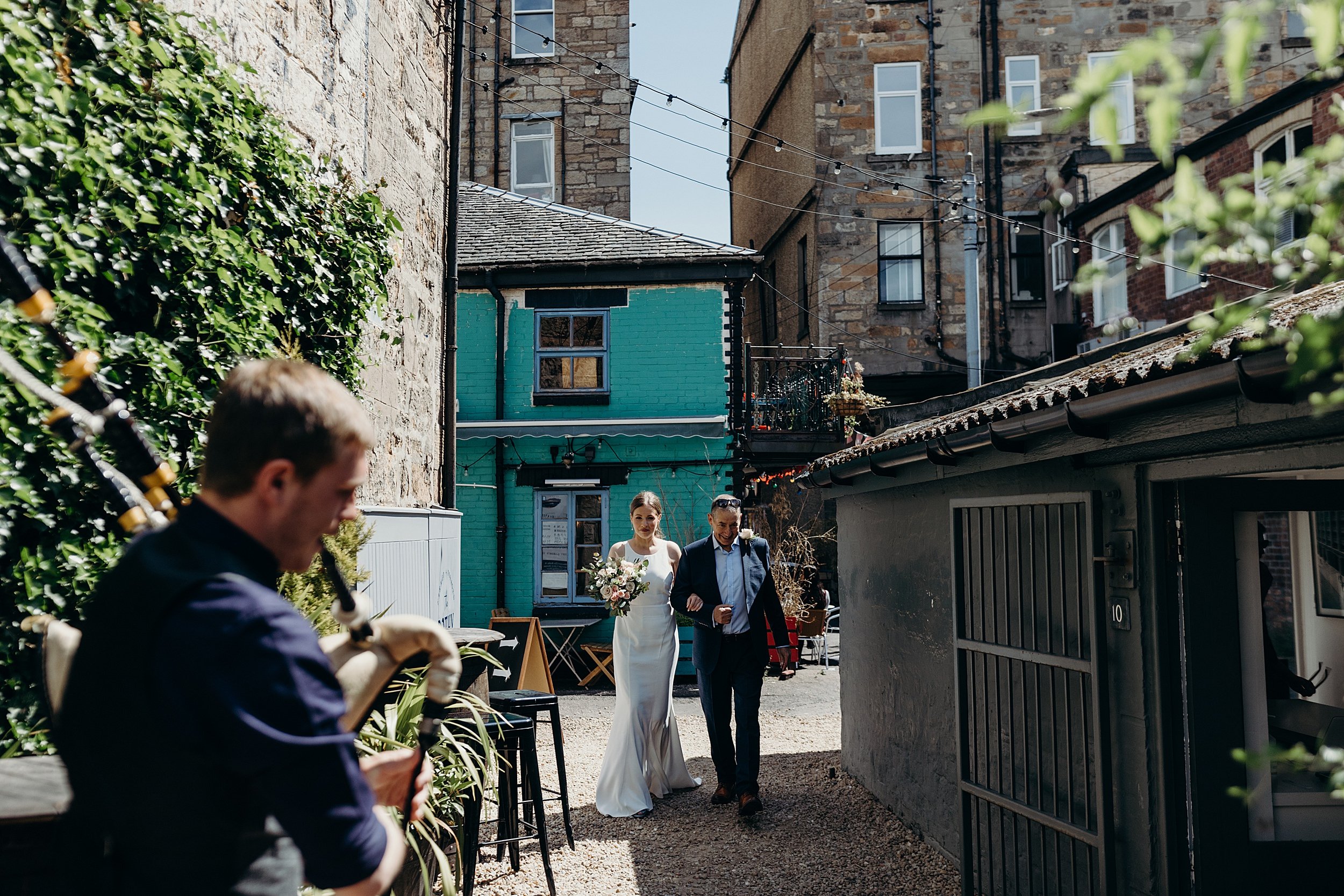 bride with her father walking down the lane outside the bothy glasgow wedding for her micro wedding ceremony