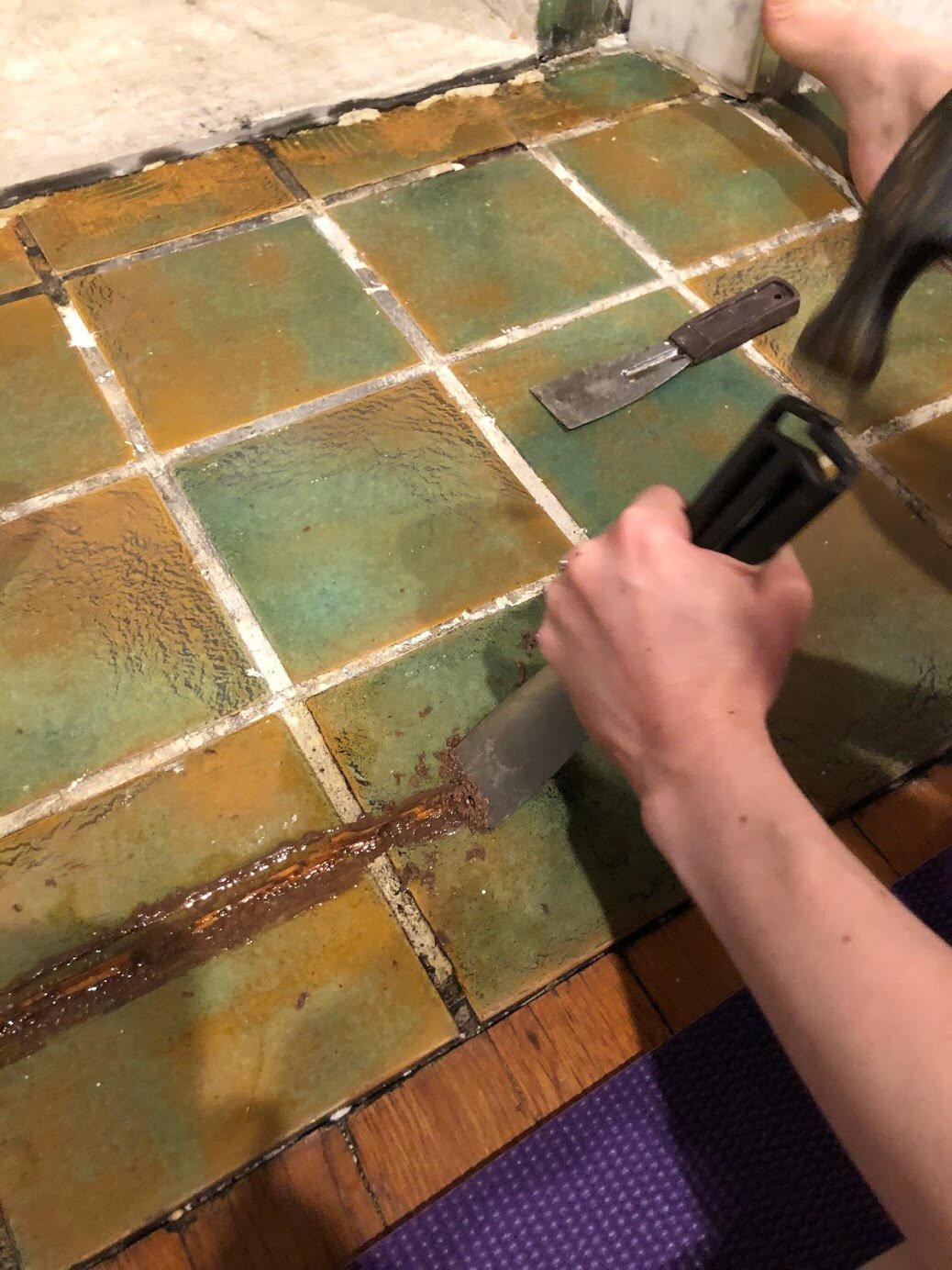  Using a putty knife and hammer, gently scrape off the glue. 