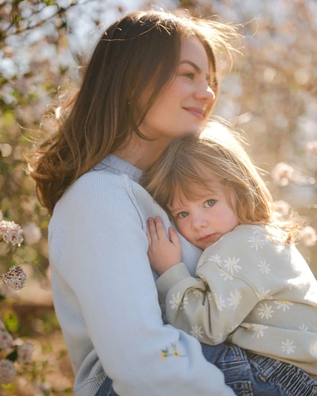There is a certain kind of magic in the quiet moments. Watching the way the light catches these two among the blooms felt like witnessing a core memory in the making. Mama looks so beautiful and happy with her baby girl in her arms. Sometimes, mother