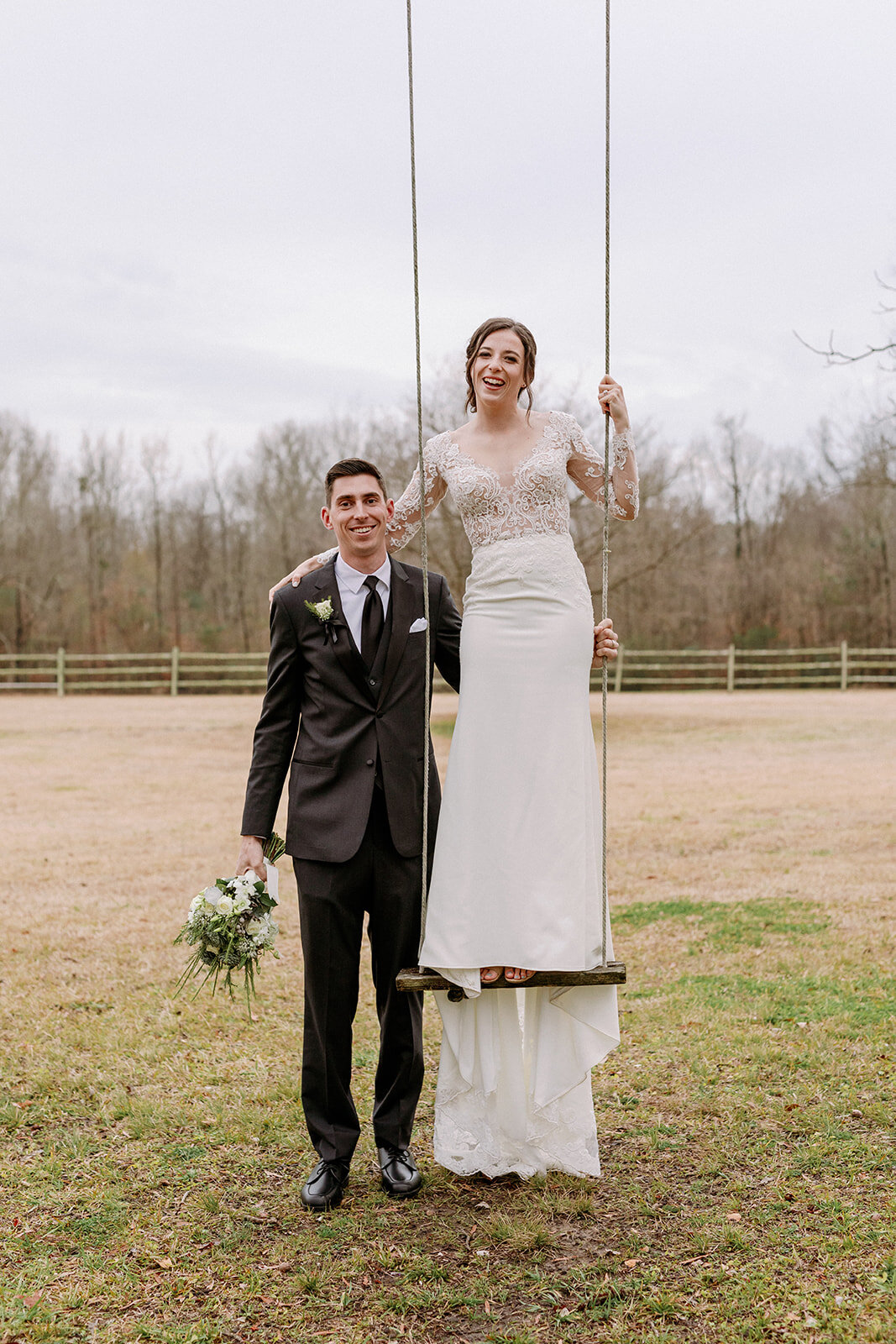 Winter-Bride-Stands-on-Swing-Tall-Groom.jpg