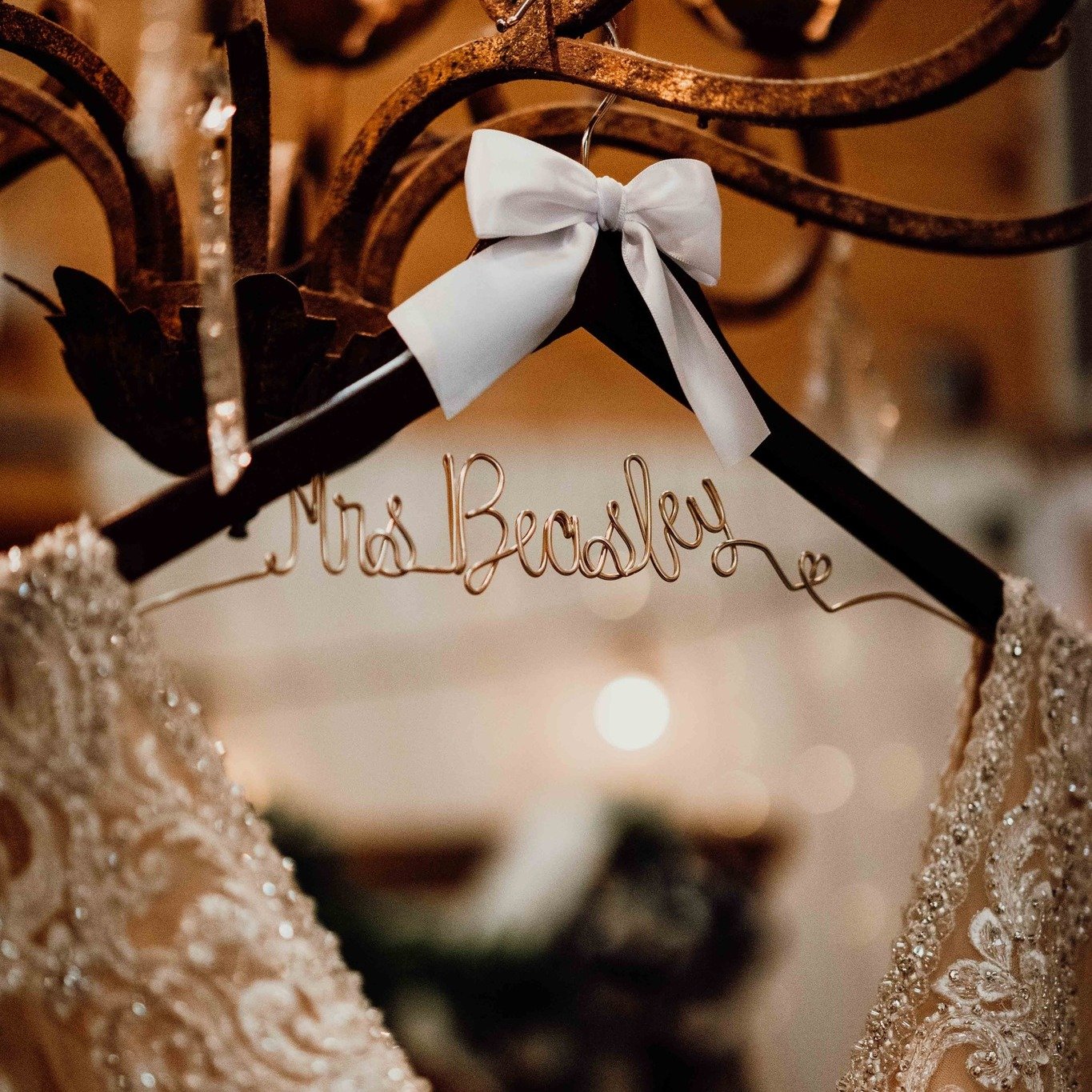 CloseUp-Bridal-Dress-Hanging-On-Gold-Chandelier.jpg