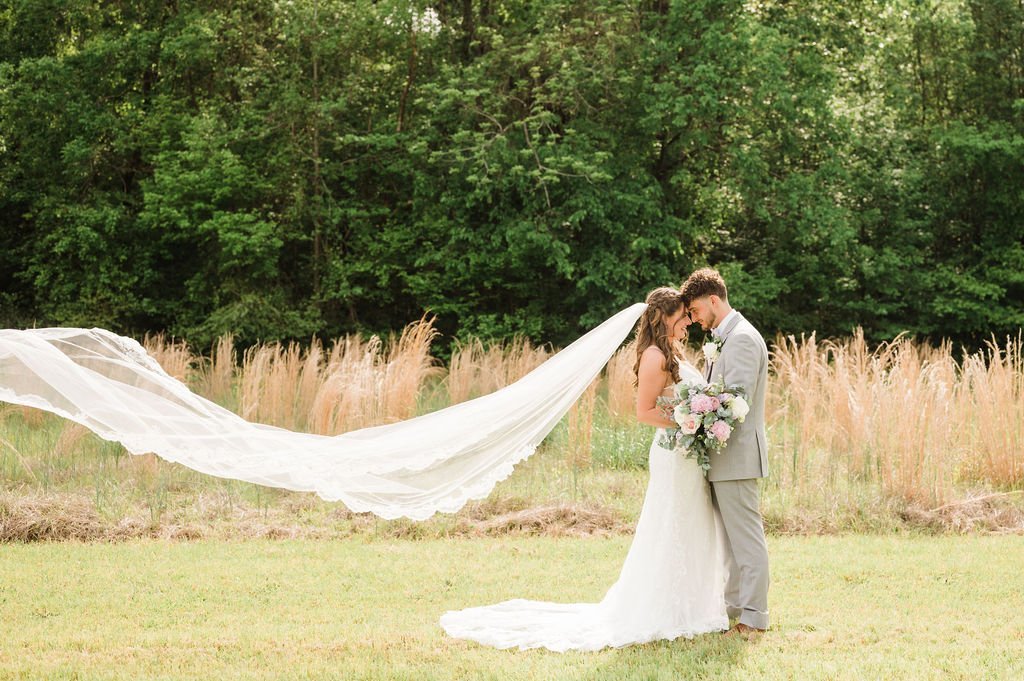 Blowing-Wedding-Veil-Couple-In-Field-.jpg