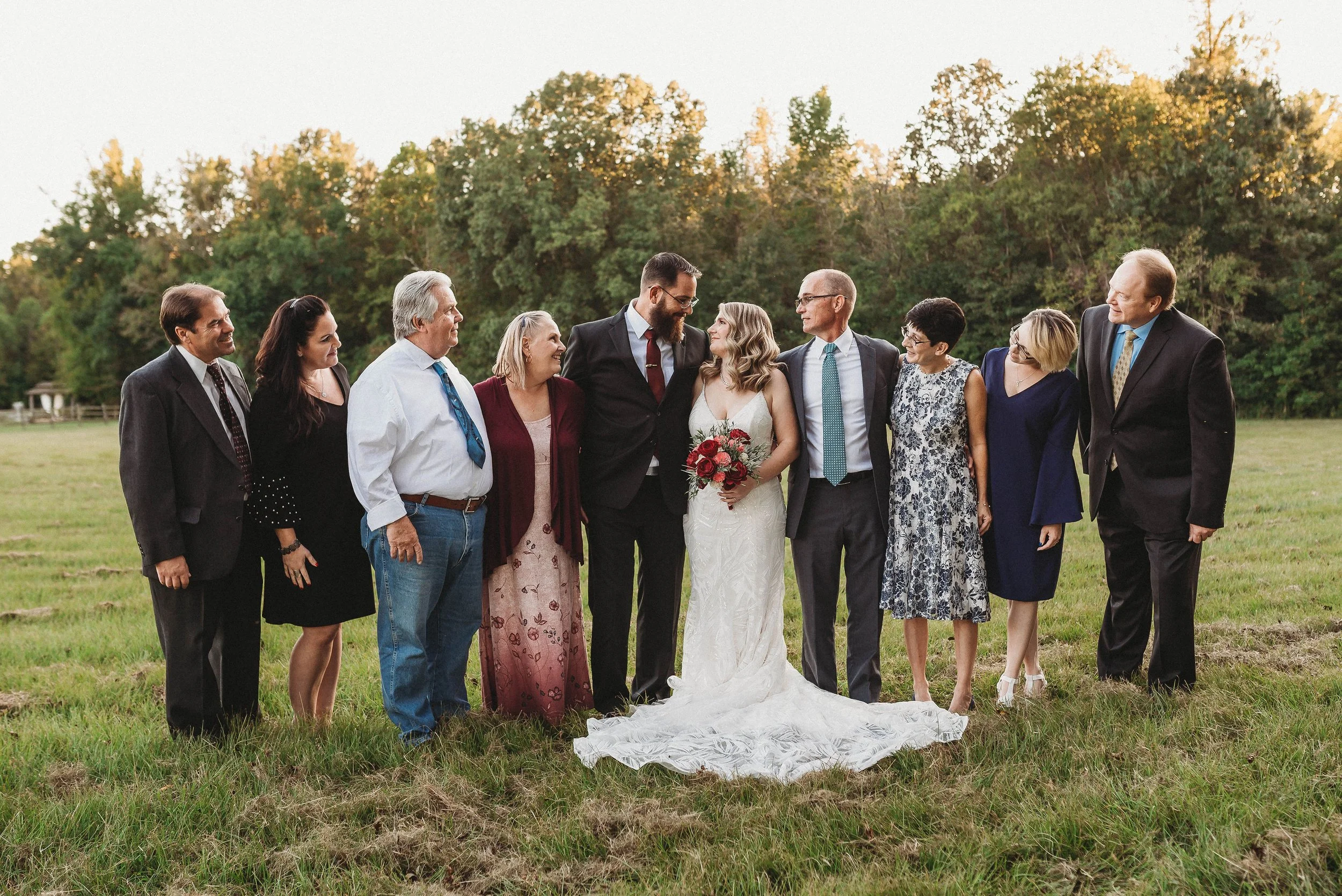 Bridal-Couple-with-Families-In-Field.jpg