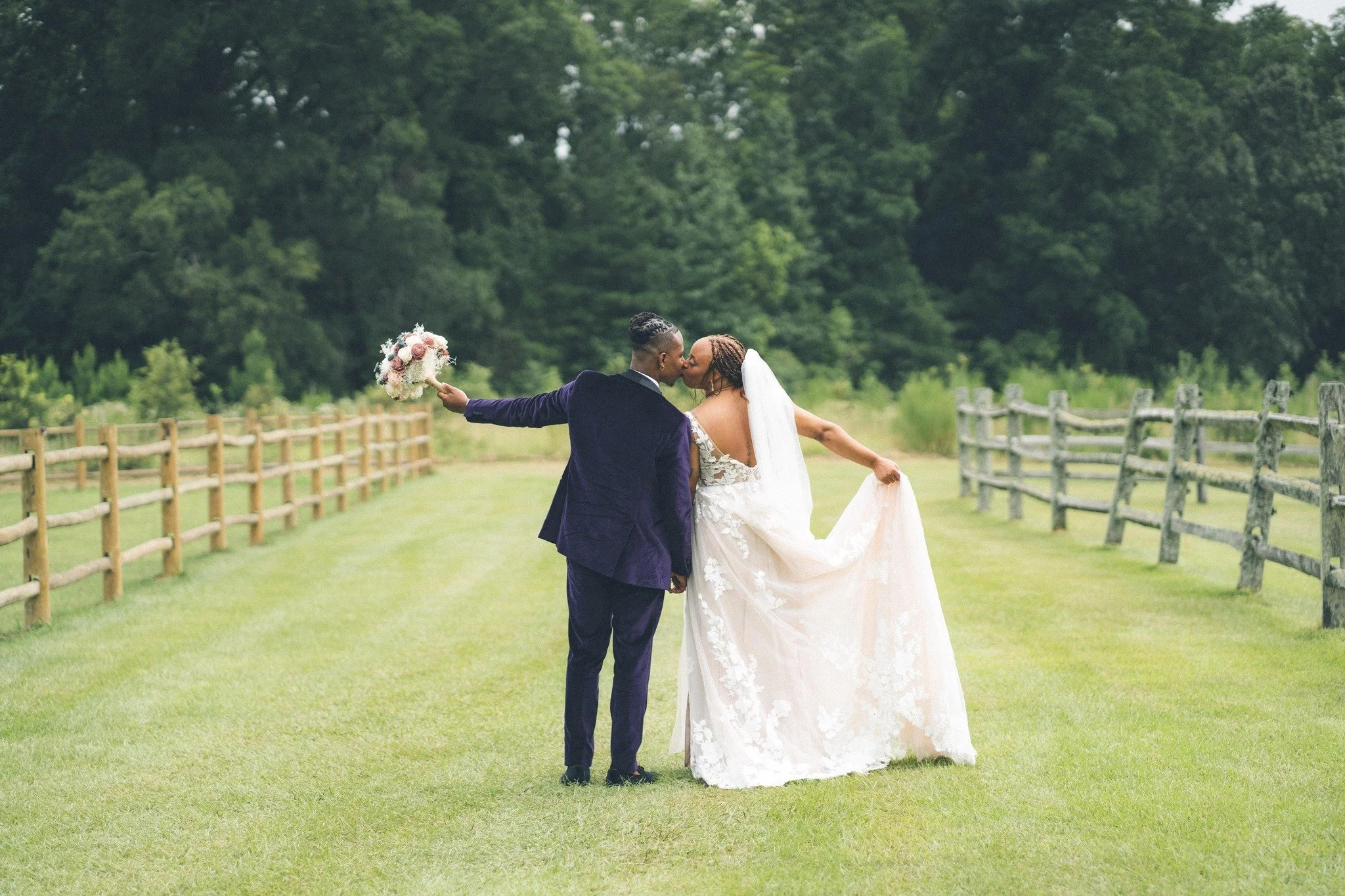 Wedding-Kiss-Backs-of-Couple-Fenceline-.jpg