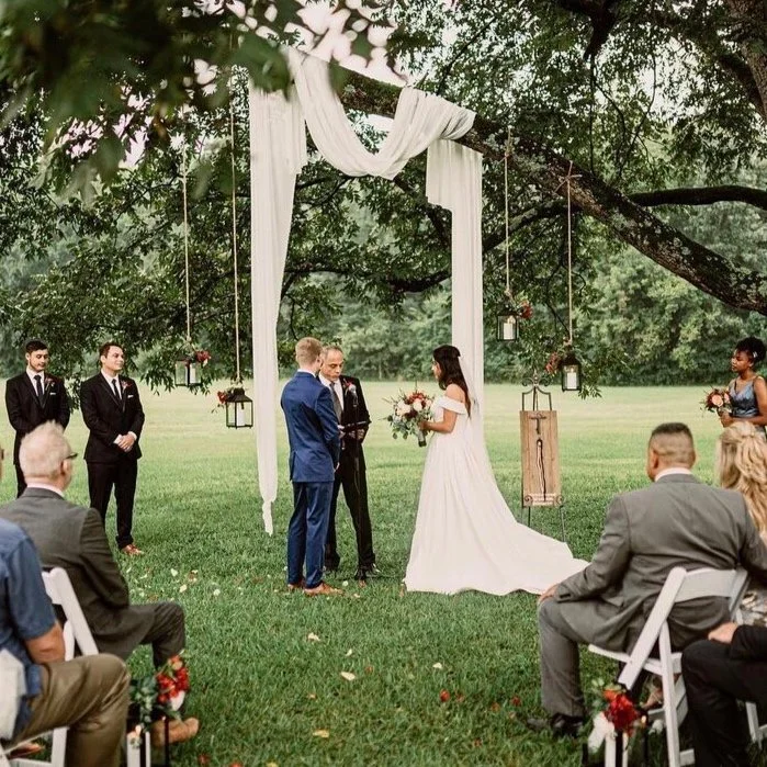 Intimate outdoor wedding ceremony under large tree at The Catlett Farm