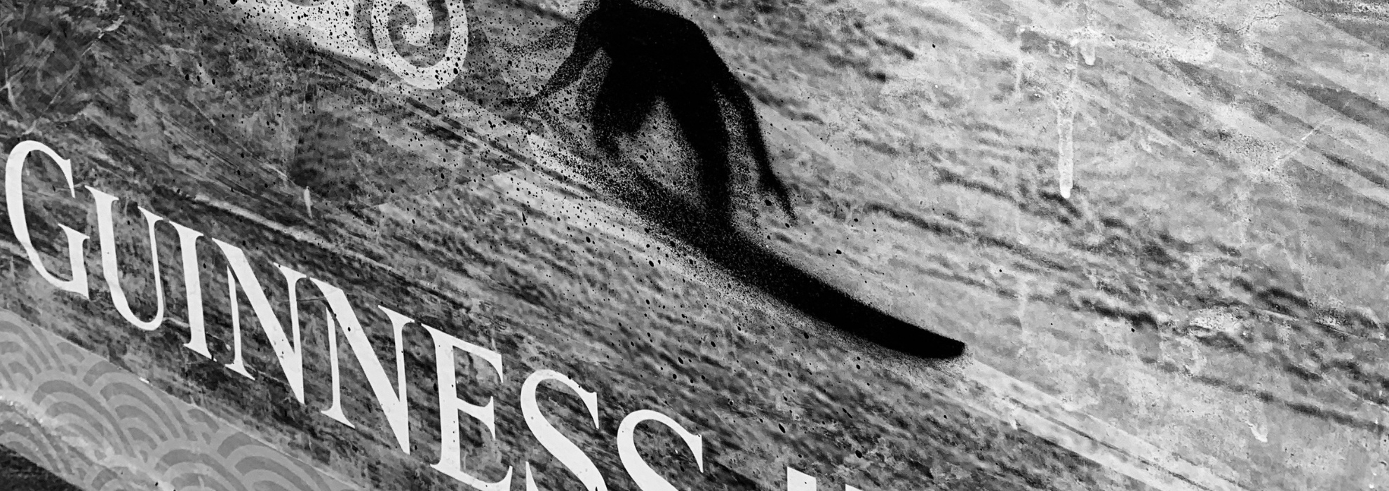 Close-up of the Guinness mural lettering and textured wall