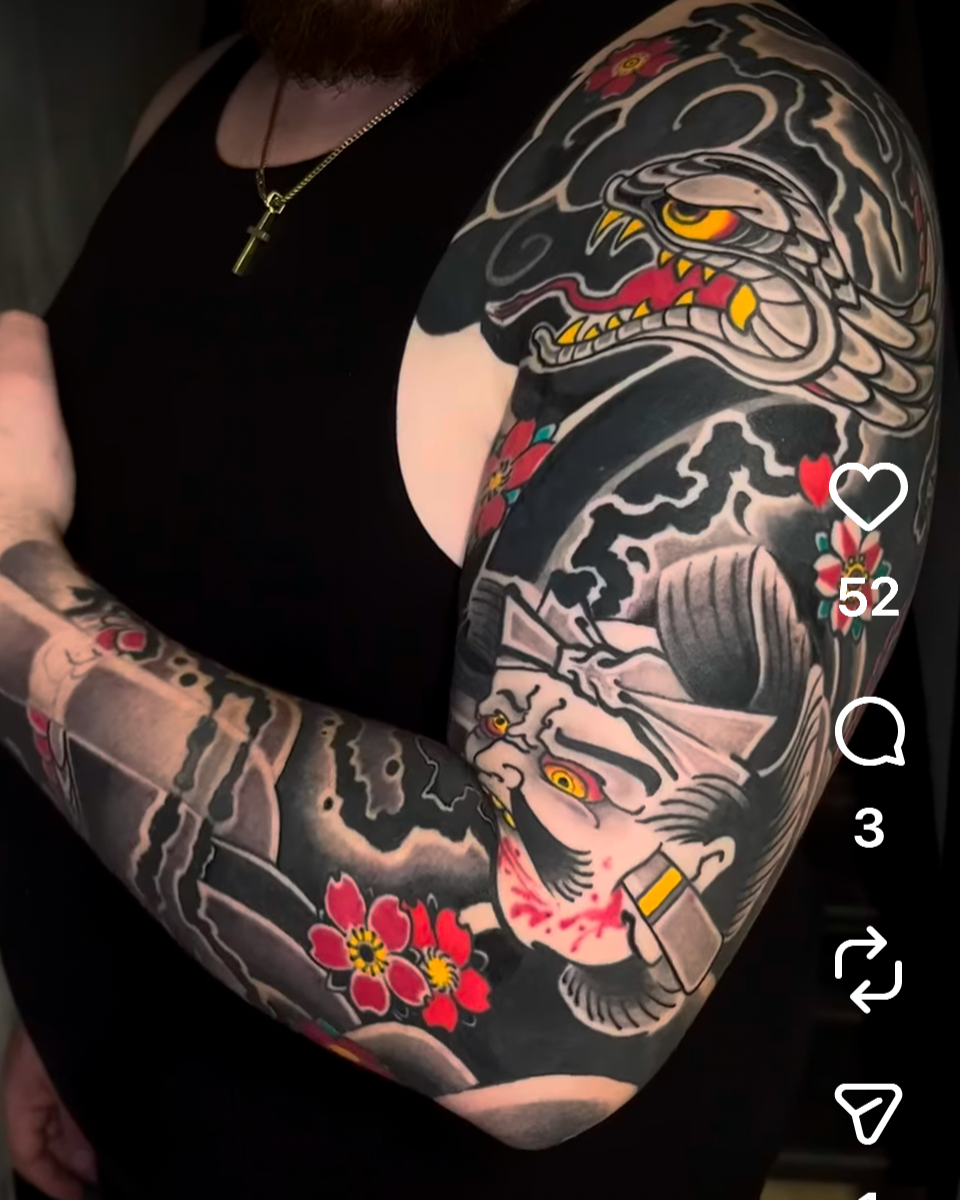 Japanese-inspired sleeve tattoo featuring a coiled snake, peonies, and flowing smoke elements.