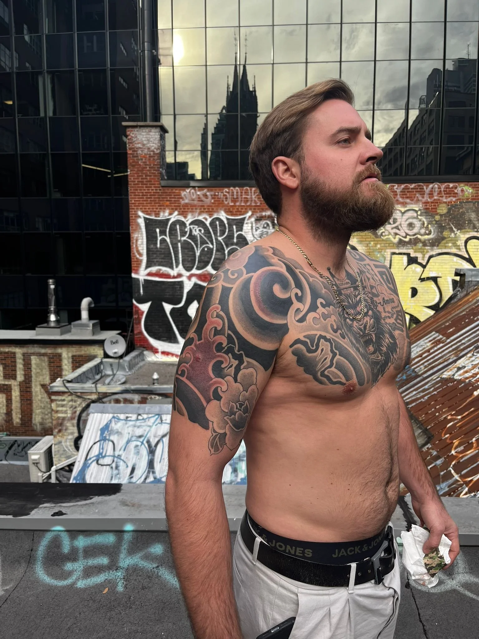 Japanese black & grey realism shoulder tattoo with flowing composition and bold line work.