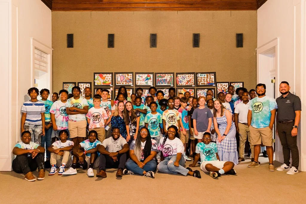CGT students and staff taking a group picture at the 2023 art show.