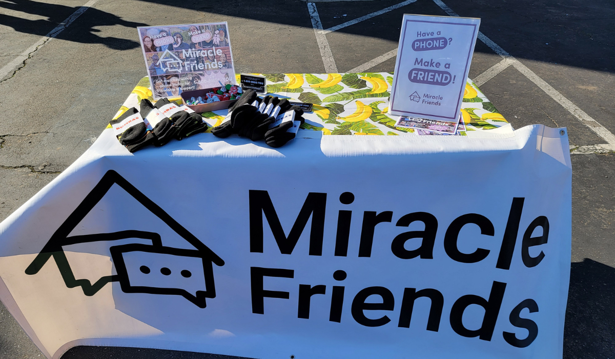 Miracle Friends' event table providing volunteer companionship services. Cardea Heath "Winter Palooza" Pop-Up Care Village in East Oakland, CA.