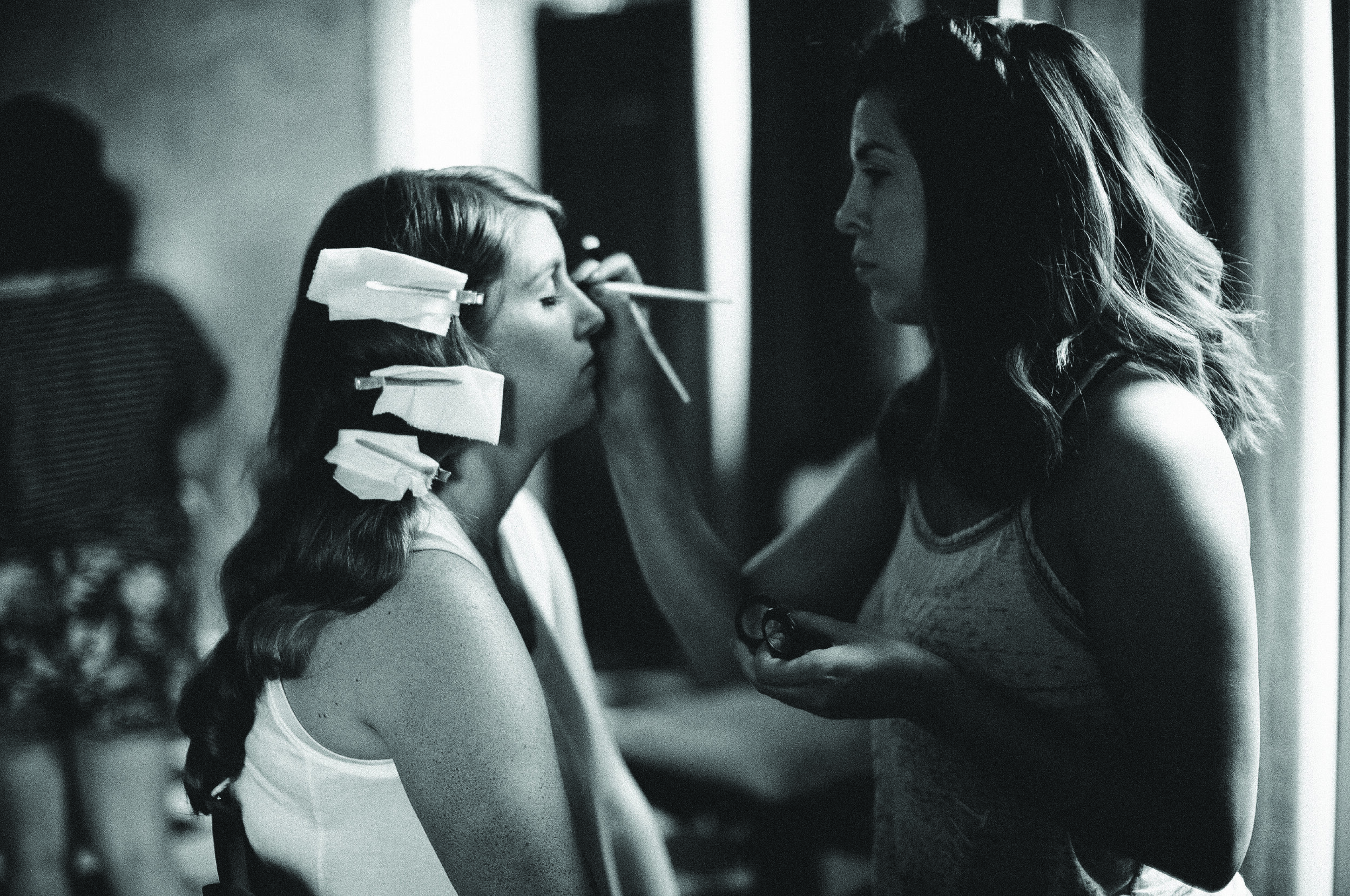 Skye Martin applying makeup on a bride at Giving Beauty Co. in Denver, CO