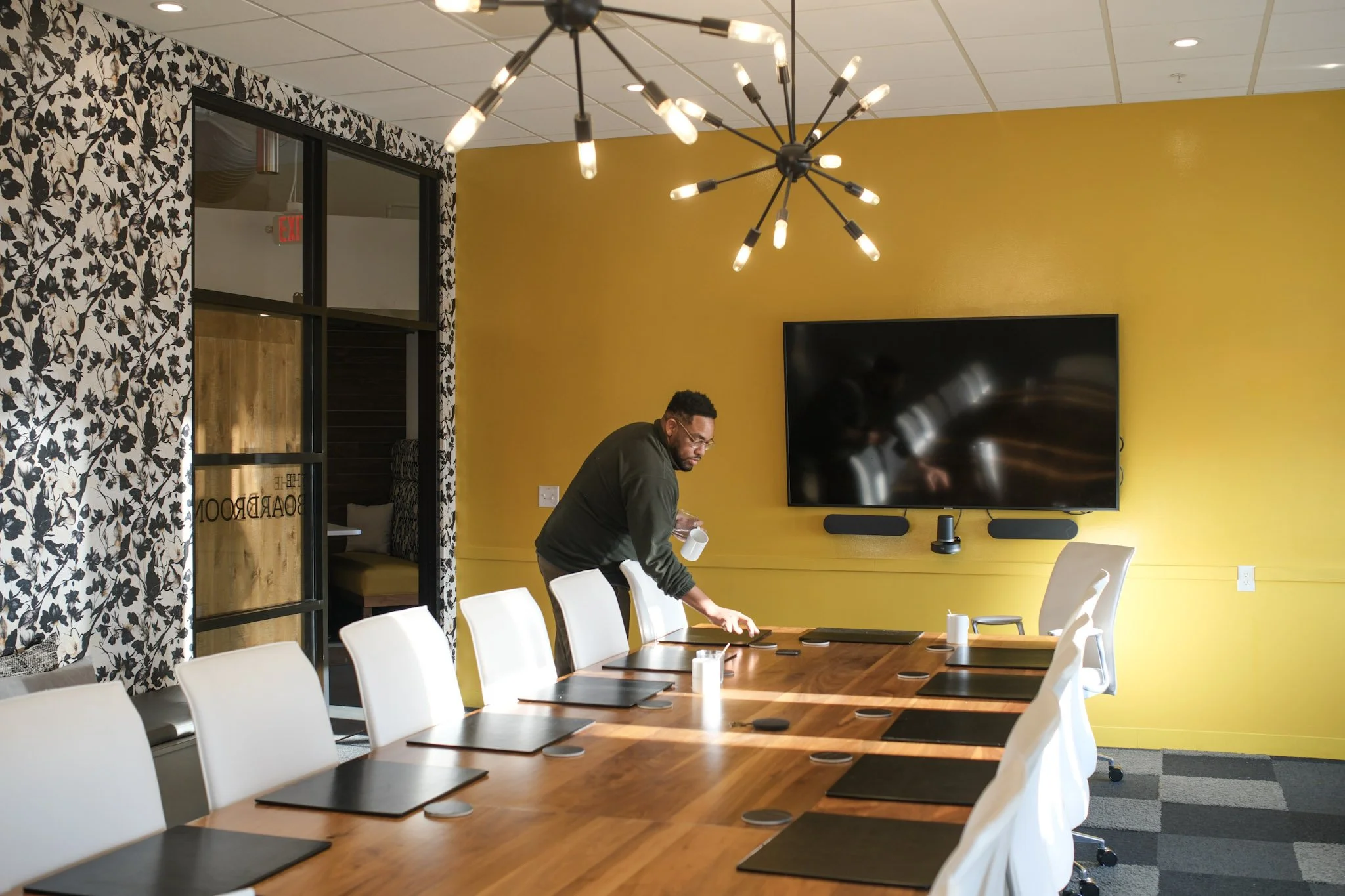 team setting up meeting in boardroom (Frisco).jpg