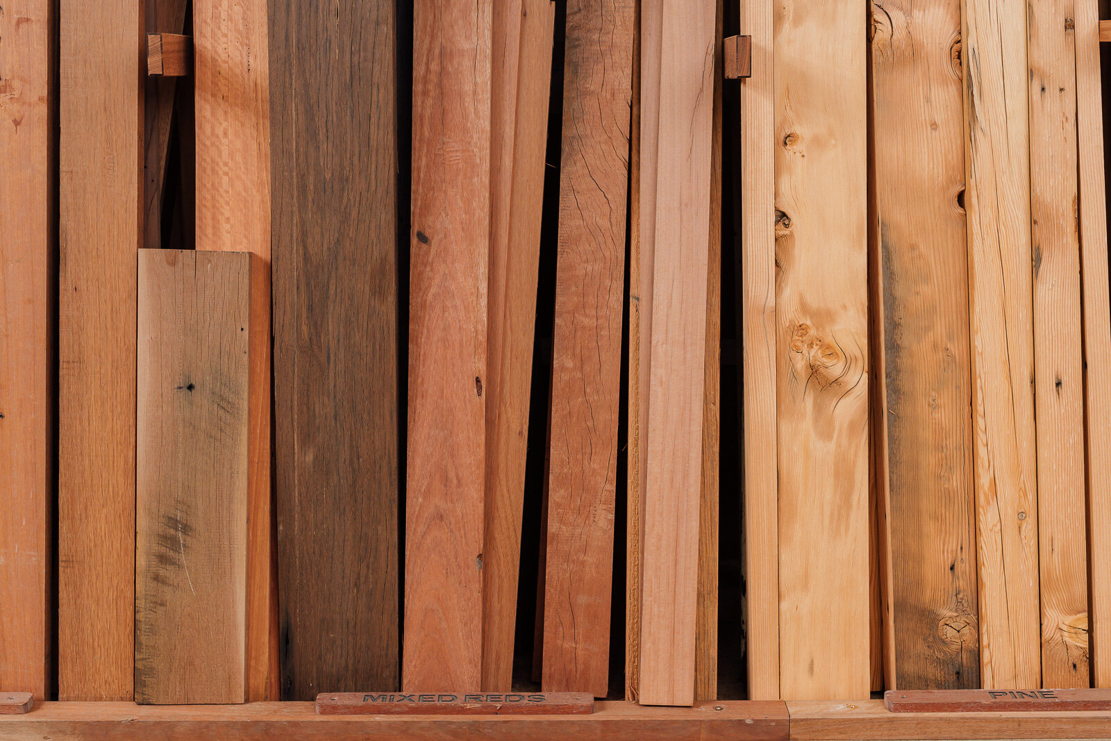 Close-up of mixed reds one-off timber slabs, stored in Thor's Hammer warehouse Canberra