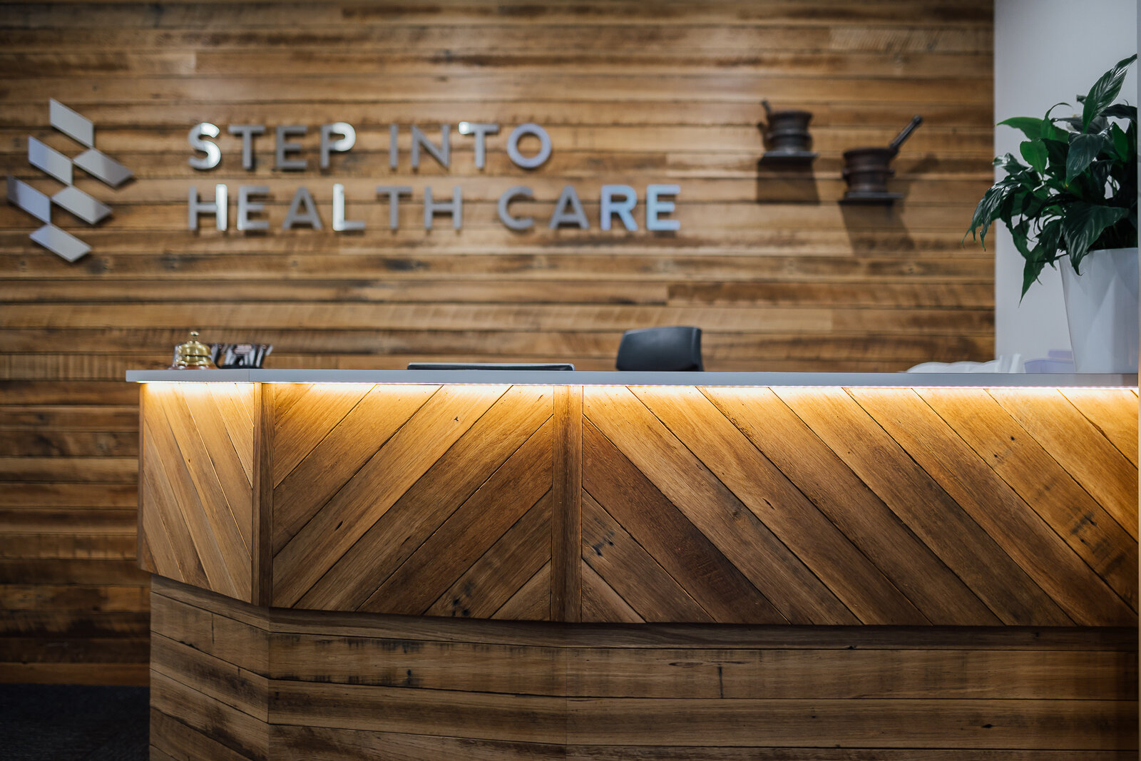 Step Into Heath Care reception with timber cladding and custom made front desk