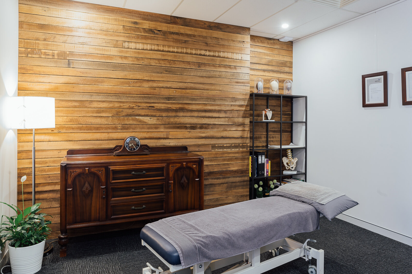 Recycled timber cladding wall with massage chair in the room