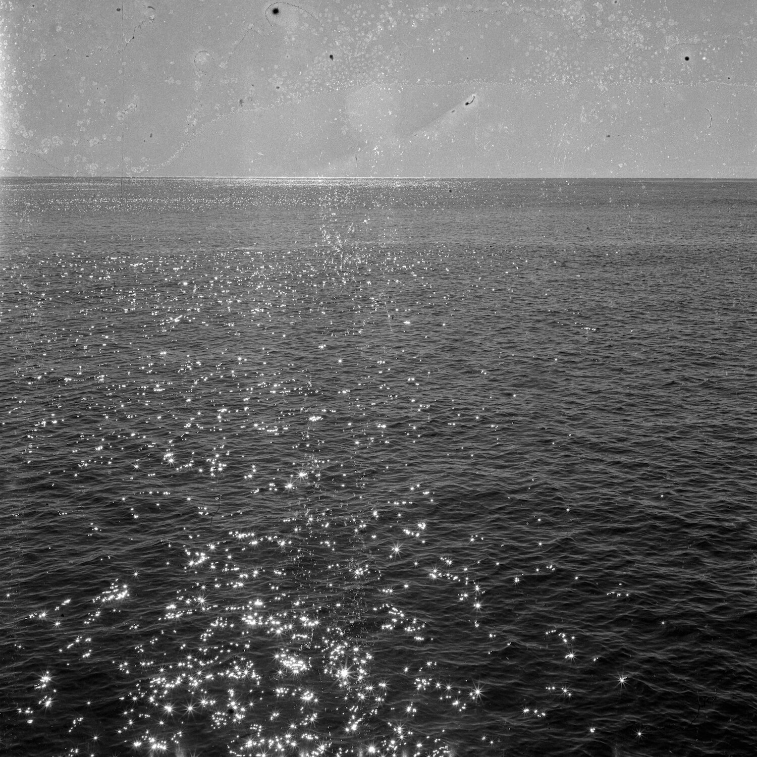   Whale Watching at Tathra Wharf, 2020, [6x6 photographic negative developed with Kodak XTOL and ocean water collected from site], pigment ink printed on archival Hahnemühle Photo Rag 308gsm paper, 60.4cm W x 85.1cm H, framed, edition of 10 + AP, sig