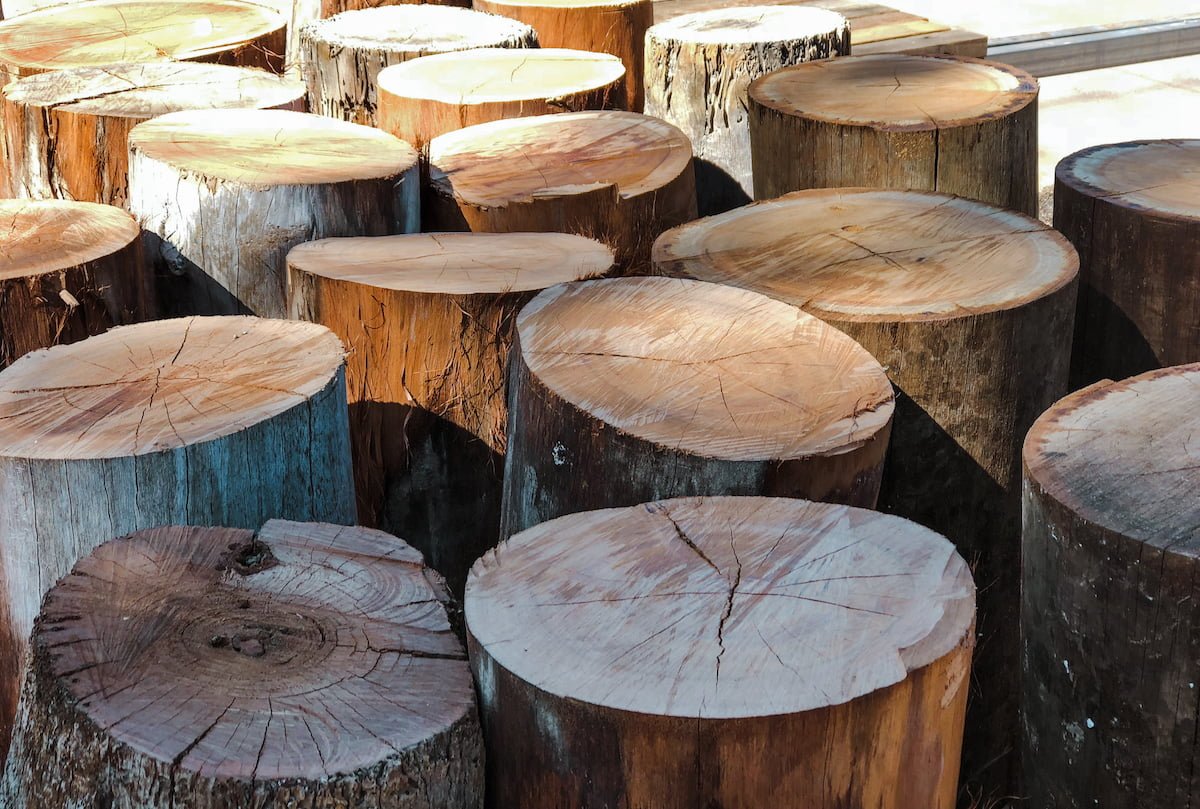 Large round recycled timber posts in an outdoor warehouse