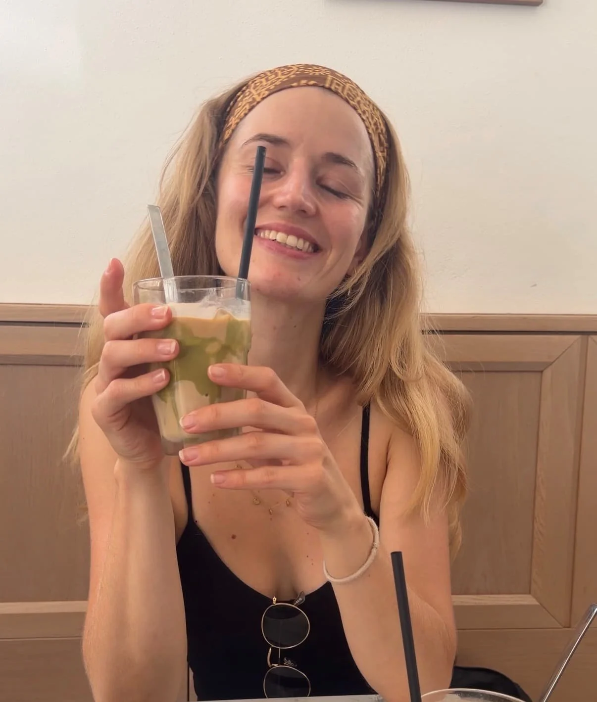 girl with her eyes closed and coffee in her hand