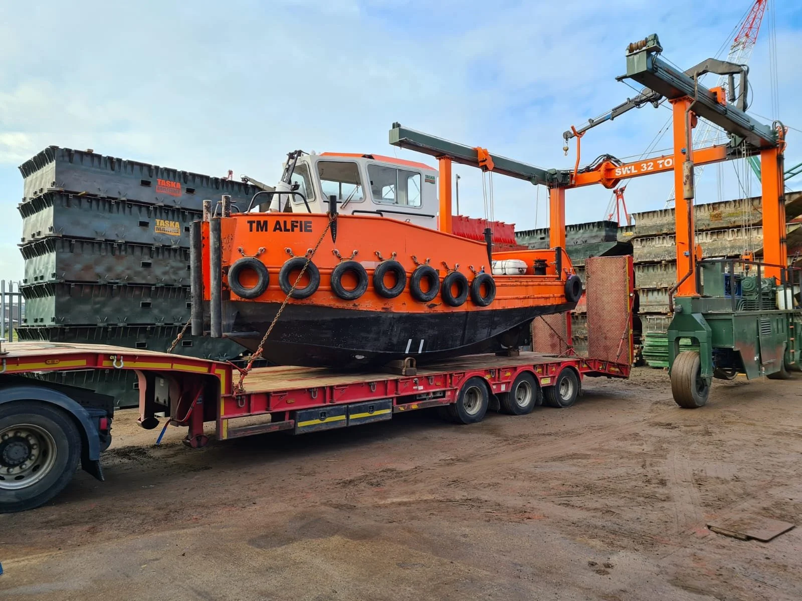 TM Alfie work boat loaded on road transport trailer