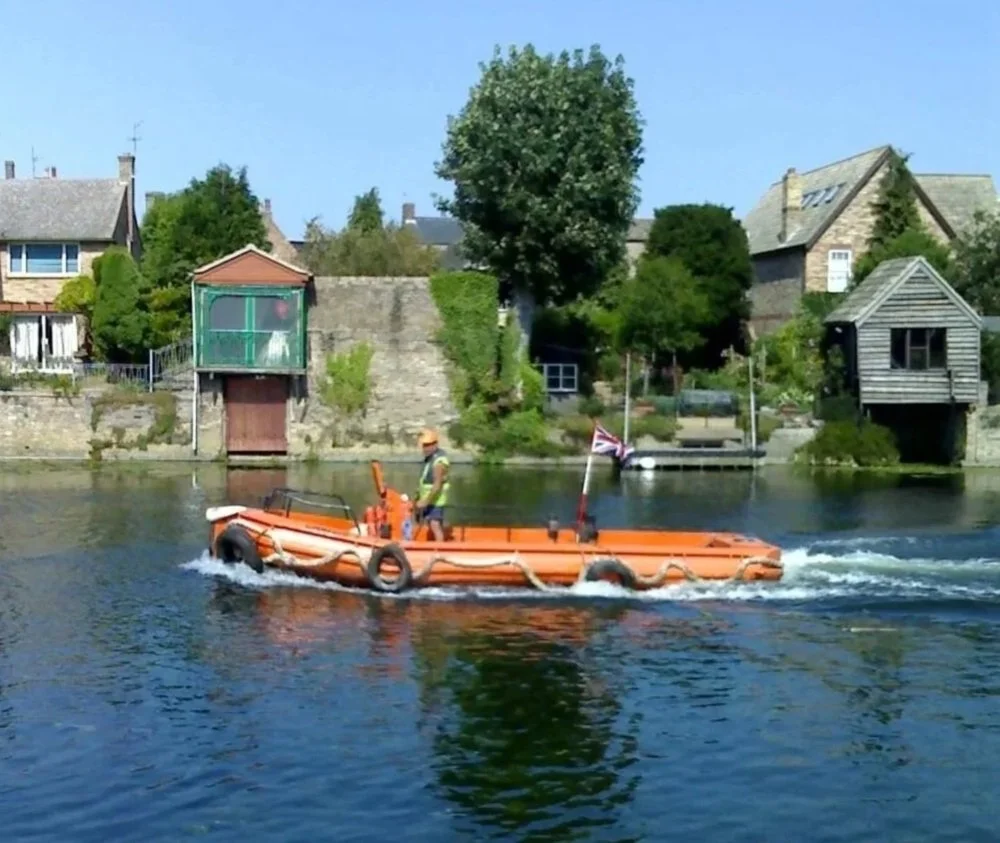 7m open work boat travelling up river Thames