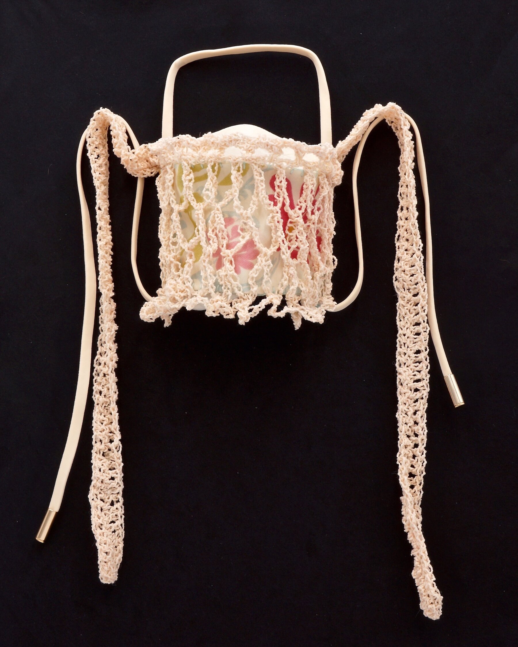    Place 4  , vintage fabric, cotton yarn, elastic cord with metal tips , crochet layered over hand sewn mask 