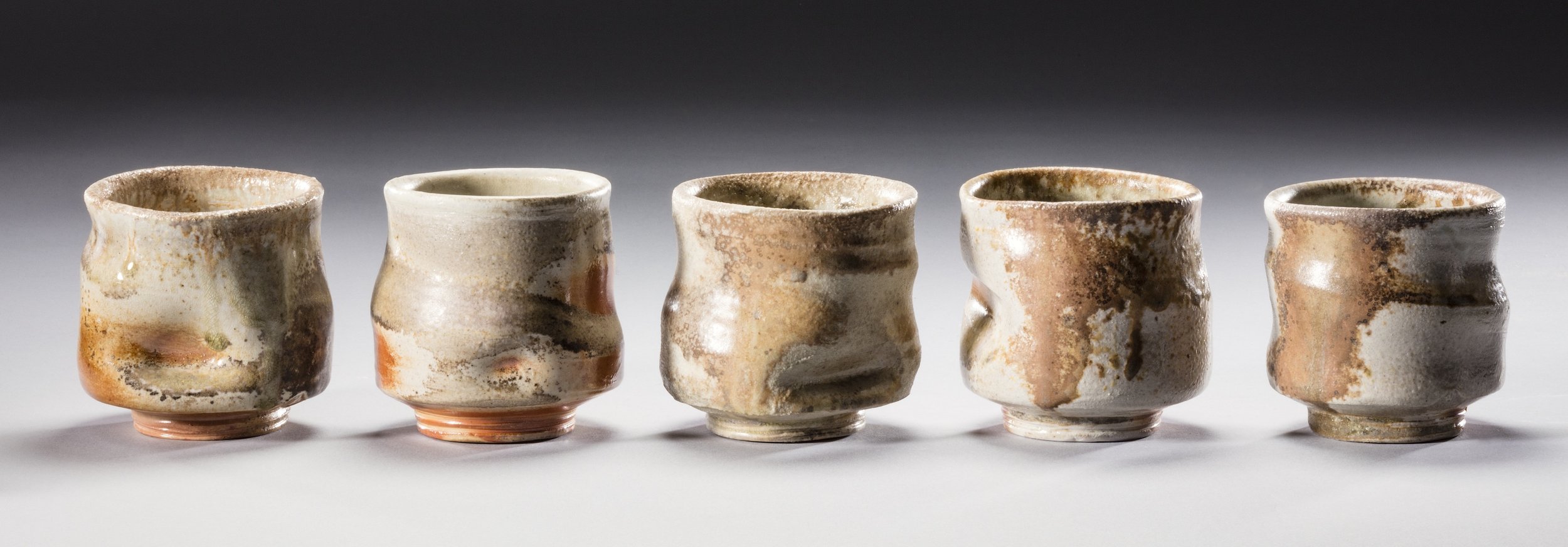    Cups  , ~3"H x 3"W each, wood fired porcelain 
