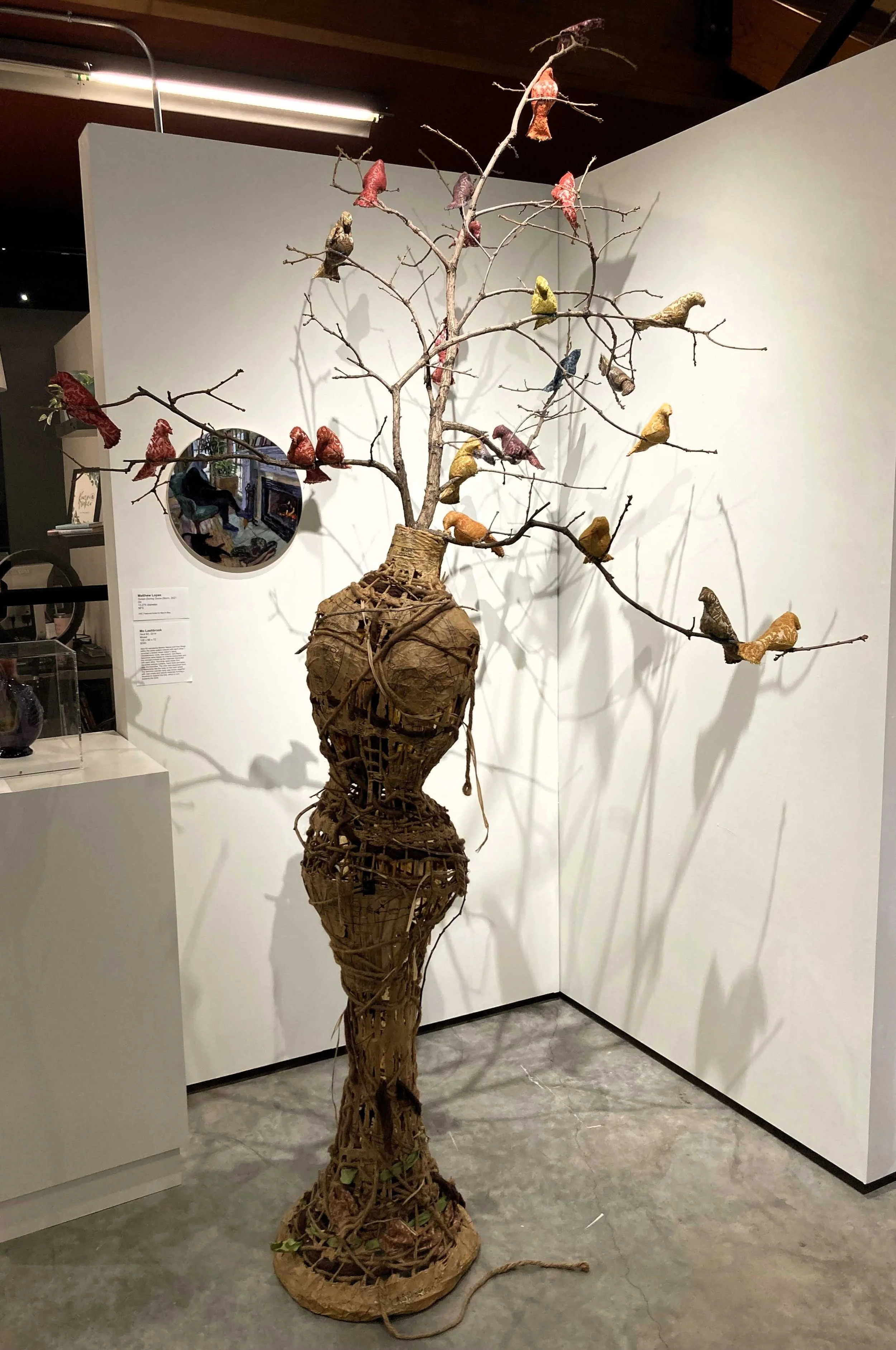    Nest #3  , rope, extension cord, curtains, dye, thread, cheese cloth, branches, raffia grass, bird nest, alpaca fibers, clothing patterns, wicker on metal dress stand, 108” x 66” x 72” 