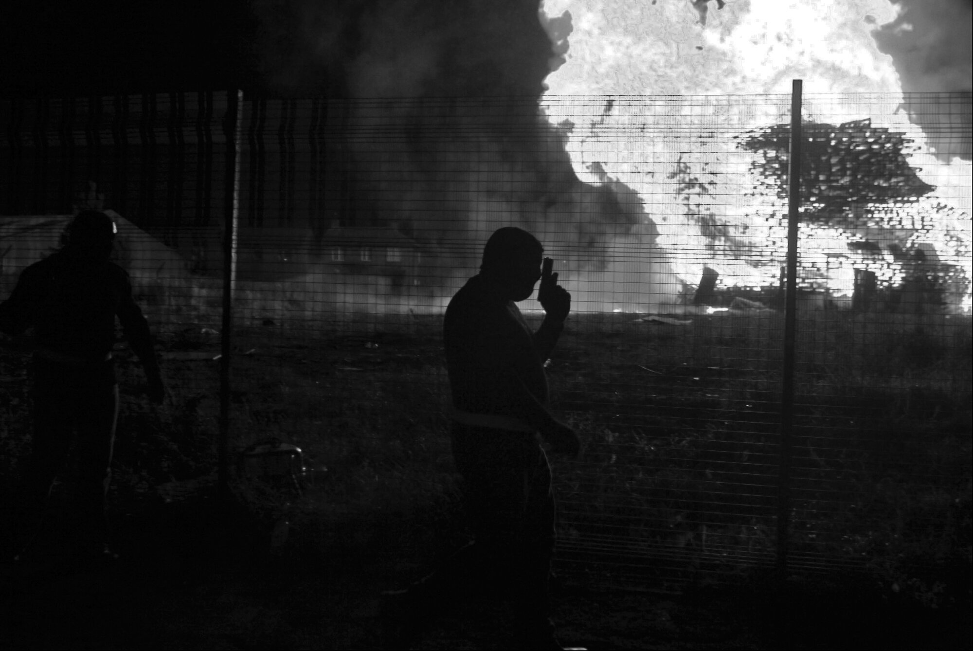 Loyalist Paramilitaries parade around a bonfire in the Shankill area of Belfast, 2000.