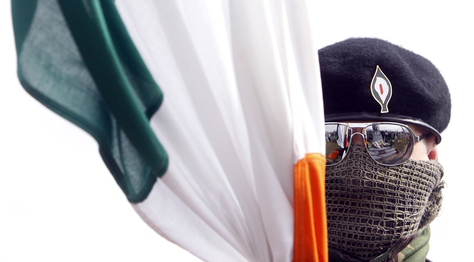 A dissident republican parades through Derry's Creggan housing estate on his way to a Republican Memorial service in the city, 2010.