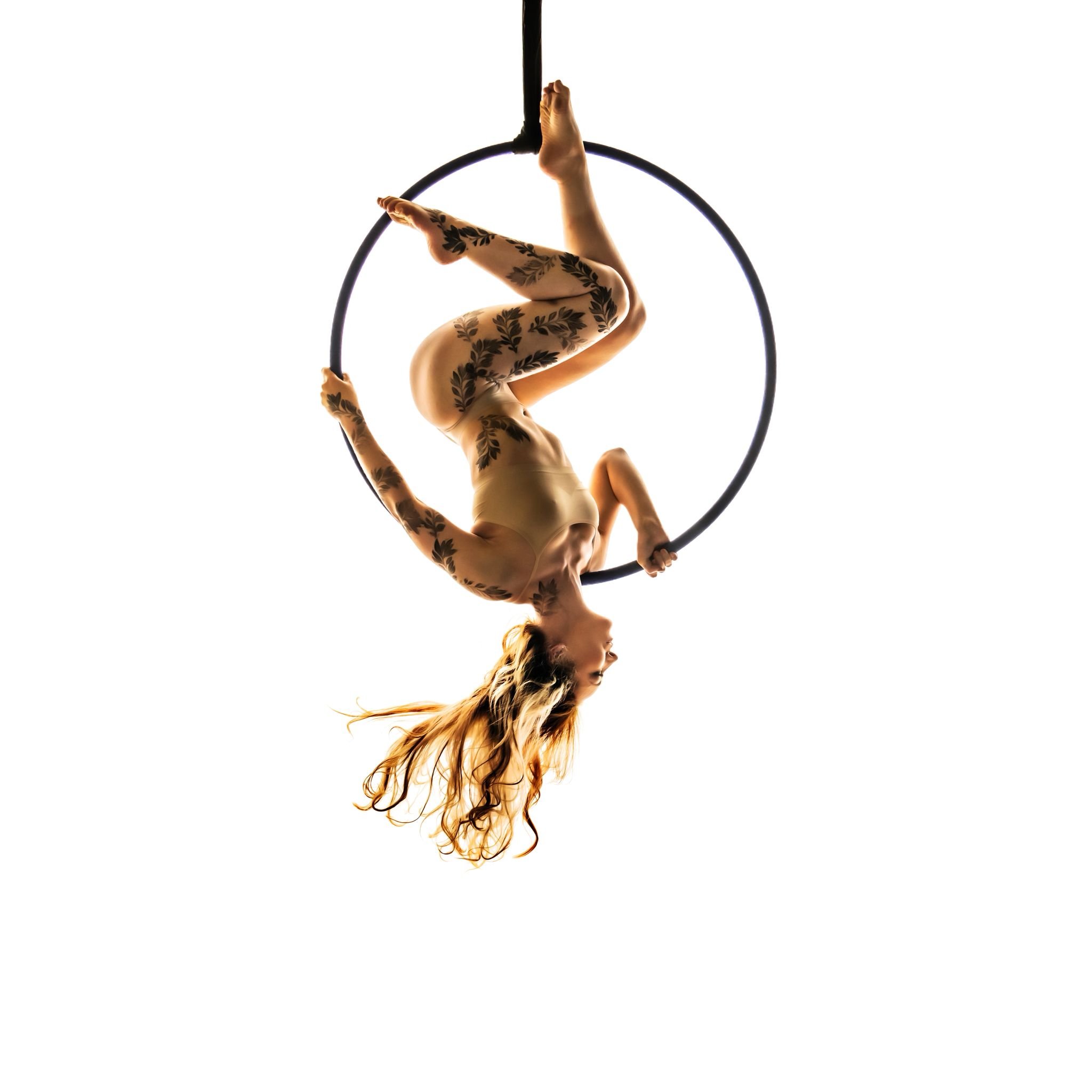 emma performing an aerial hoop shoulder stand