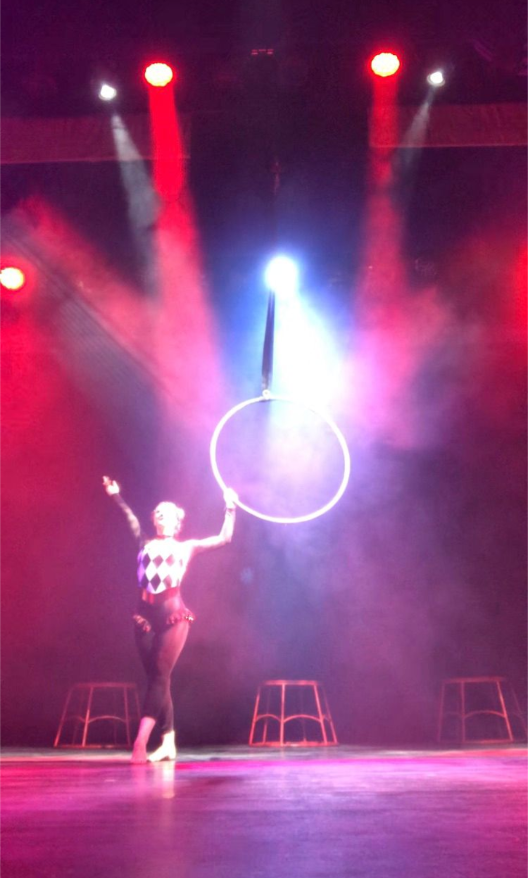 emma performing on stage with the areal hoop