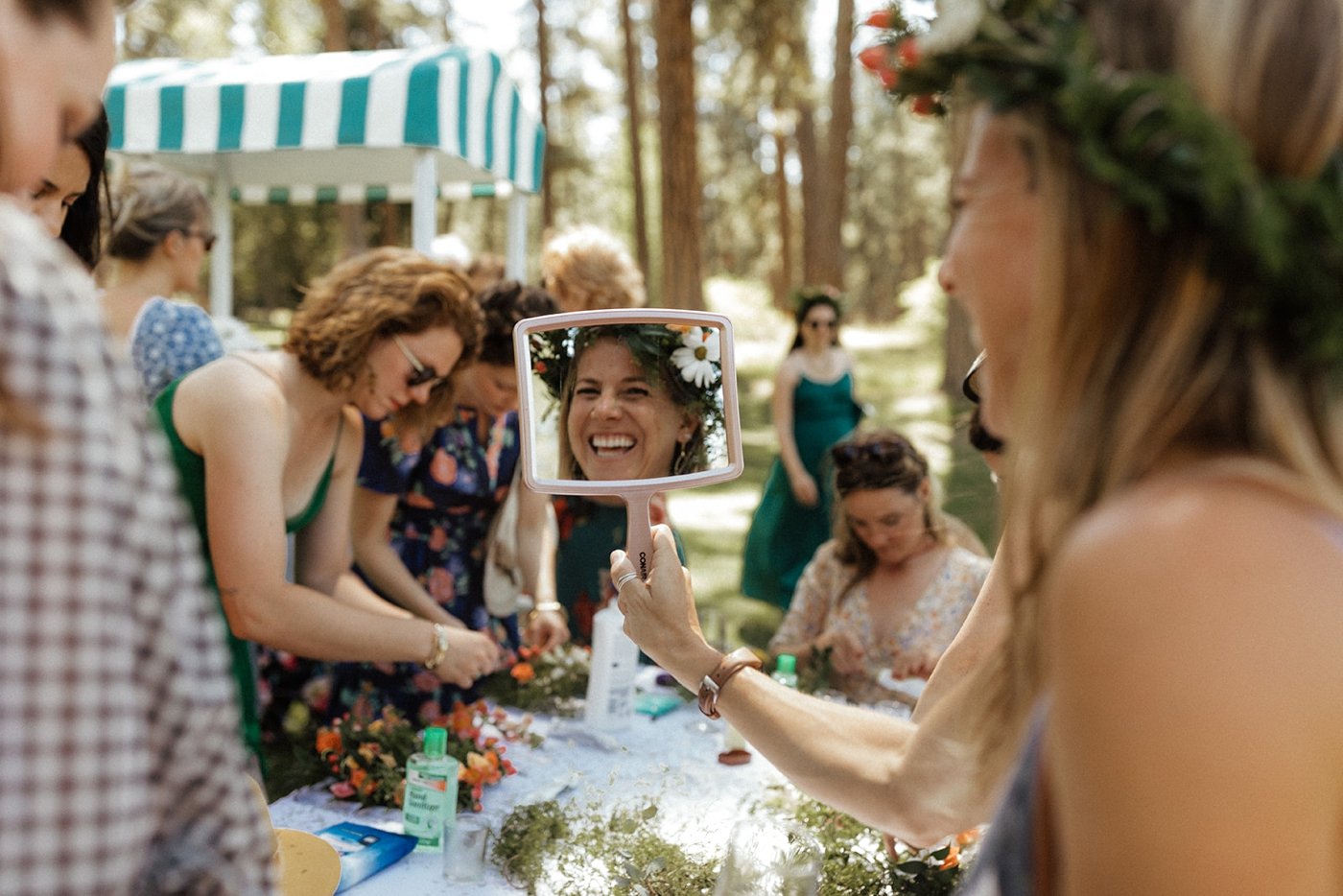 Guests making Midsummer flower crowns for an afternoon wedding