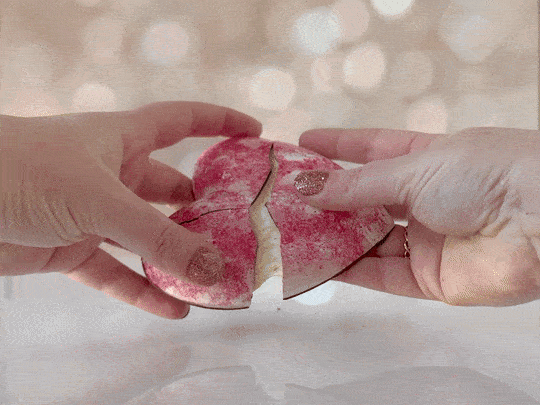 Hands pulling a Valentine Heart apart, revealing the marshmallow inside