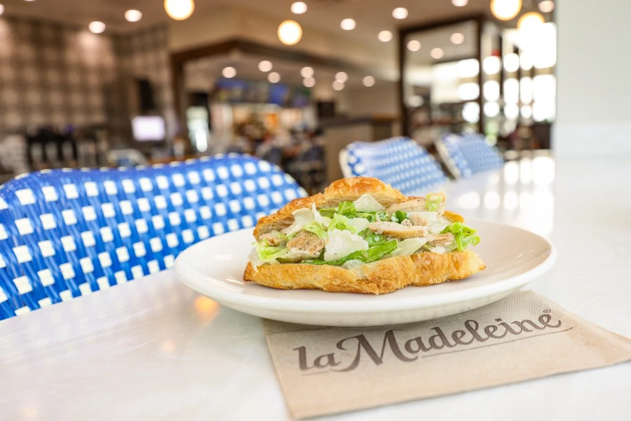 la Madeleine's Chicken Caesar Salade Stuffed Croissant on a table. Photo credit: la Madeleine