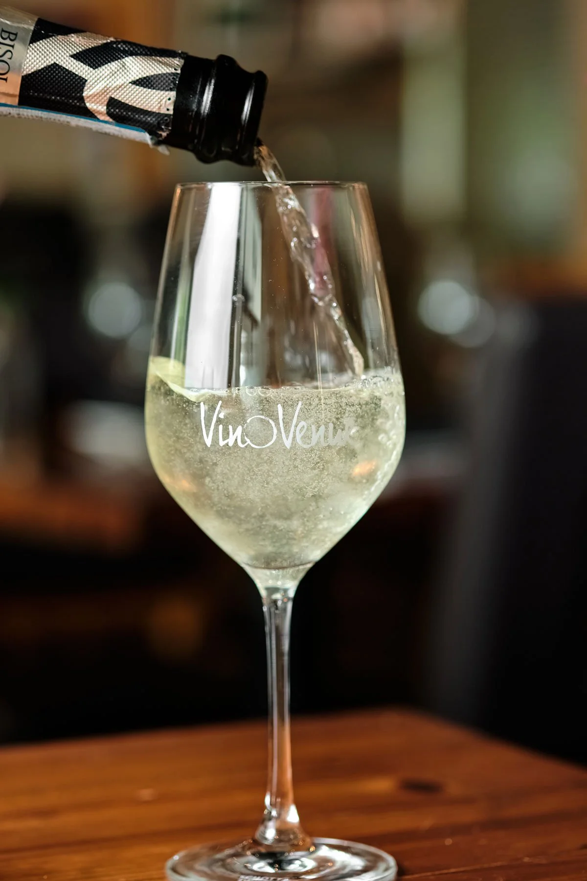 Wine being poured into a glass at Vino Venue. Photo credit: Brandon Amato - www.brandonjohnamato.com