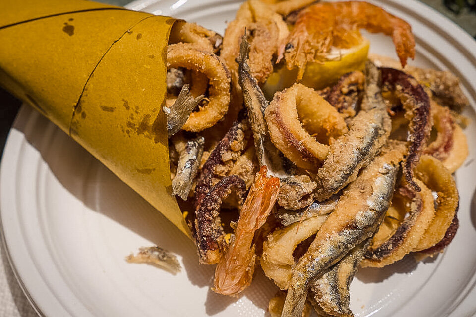 Cuoppo, the popular street food in Naples, with fried calamari (squid) and anchovies